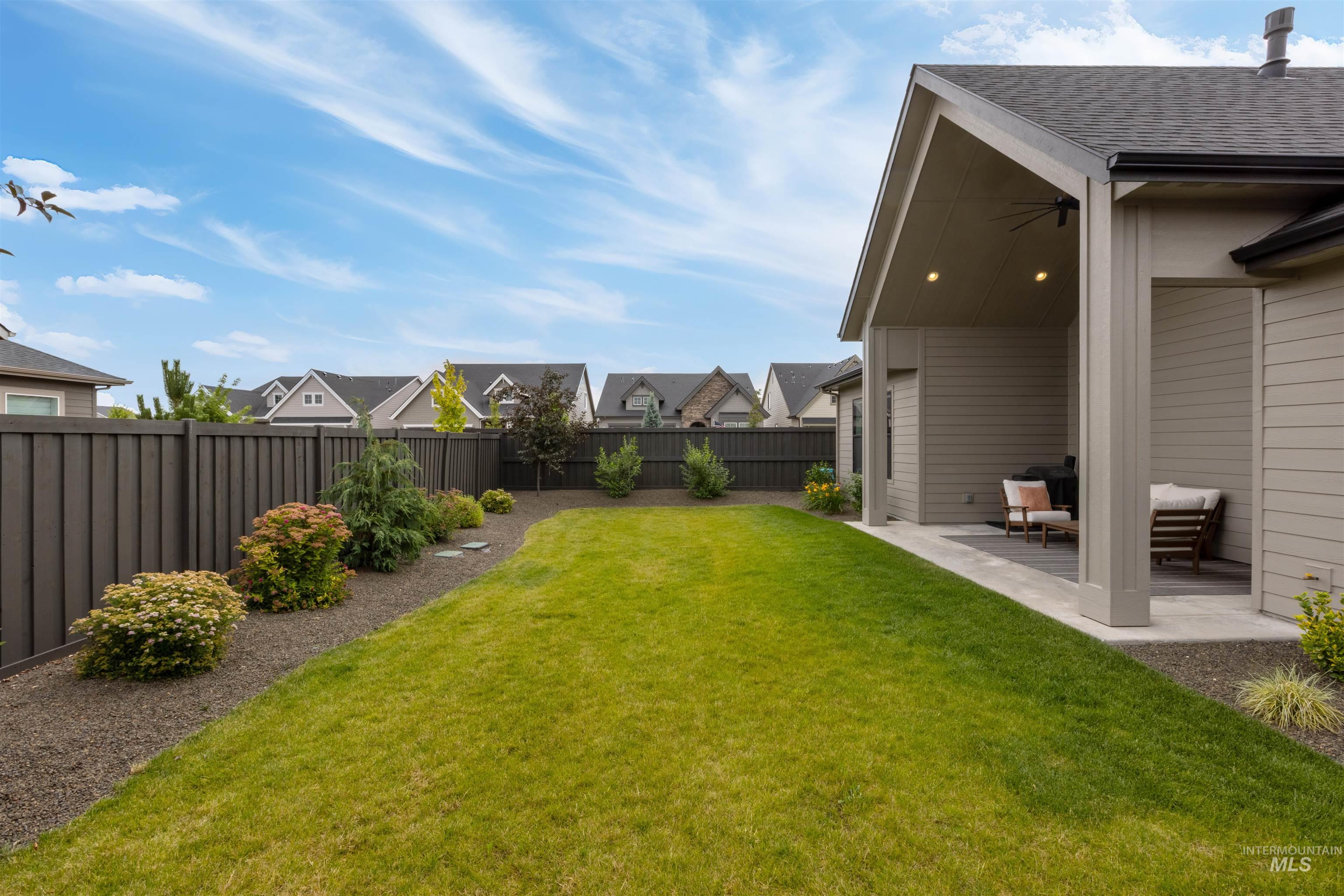 Fenced backyard with a residential view and a patio area