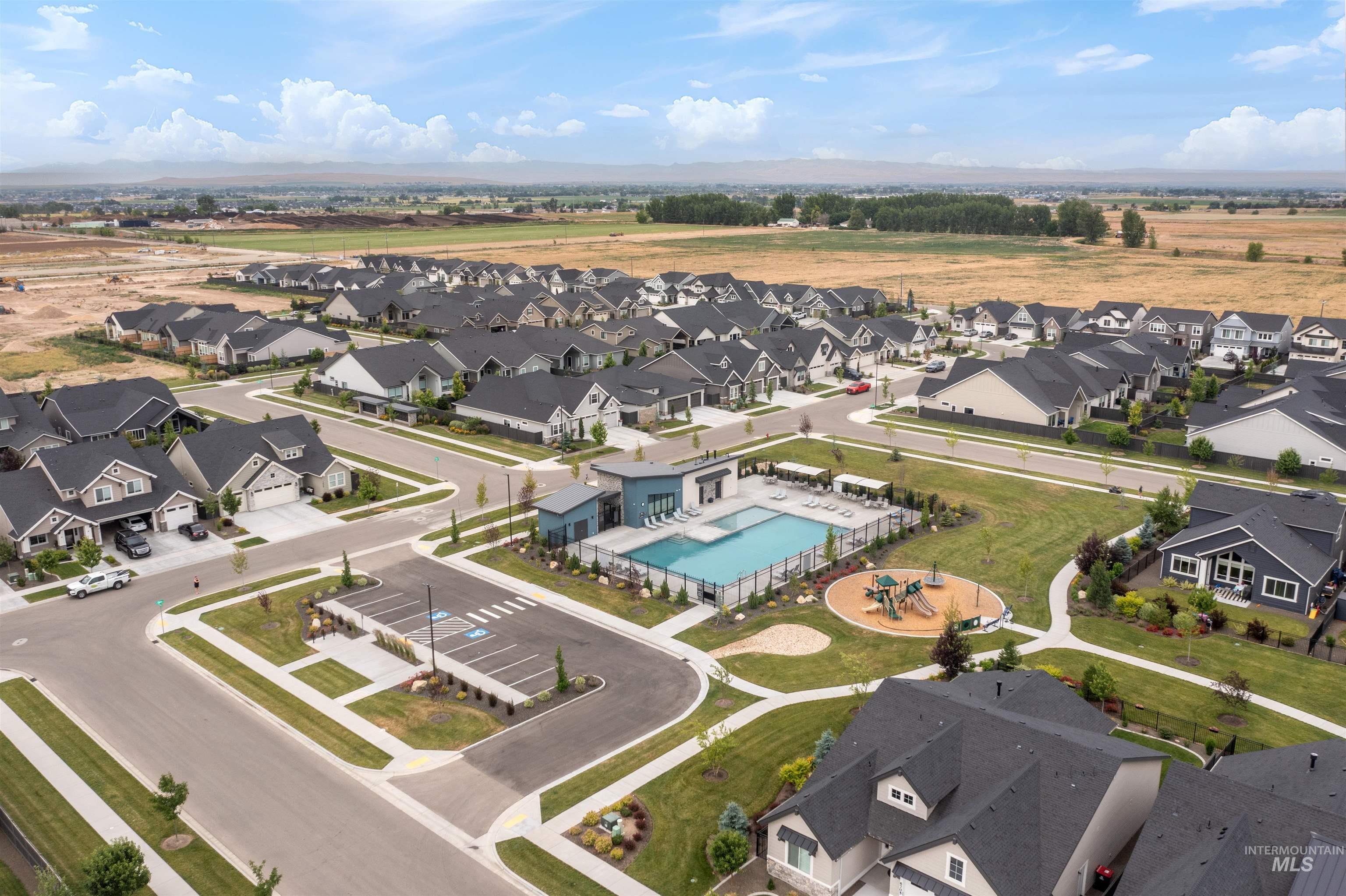 Aerial perspective of suburban area featuring a pool