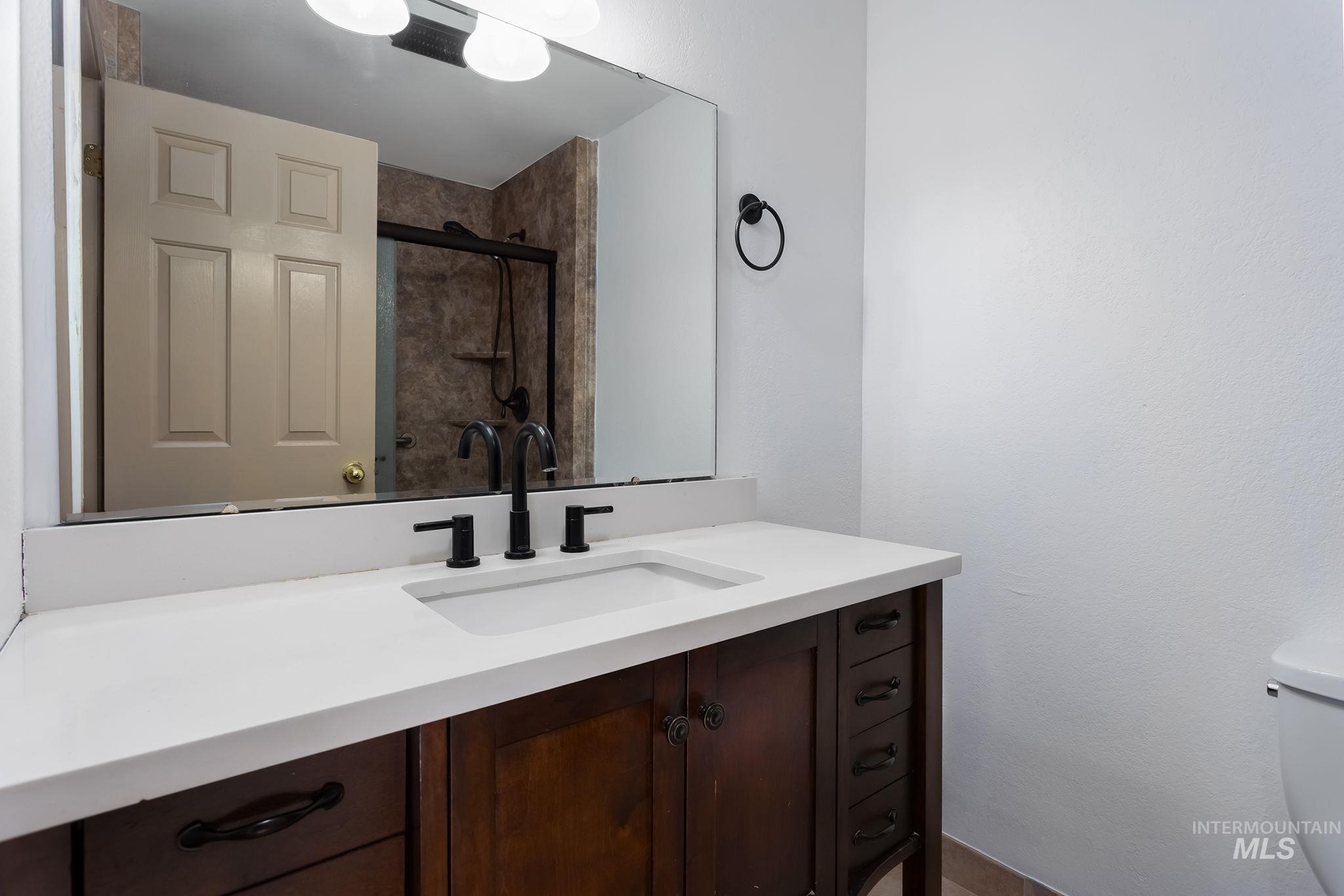 Bathroom with vanity and tiled shower
