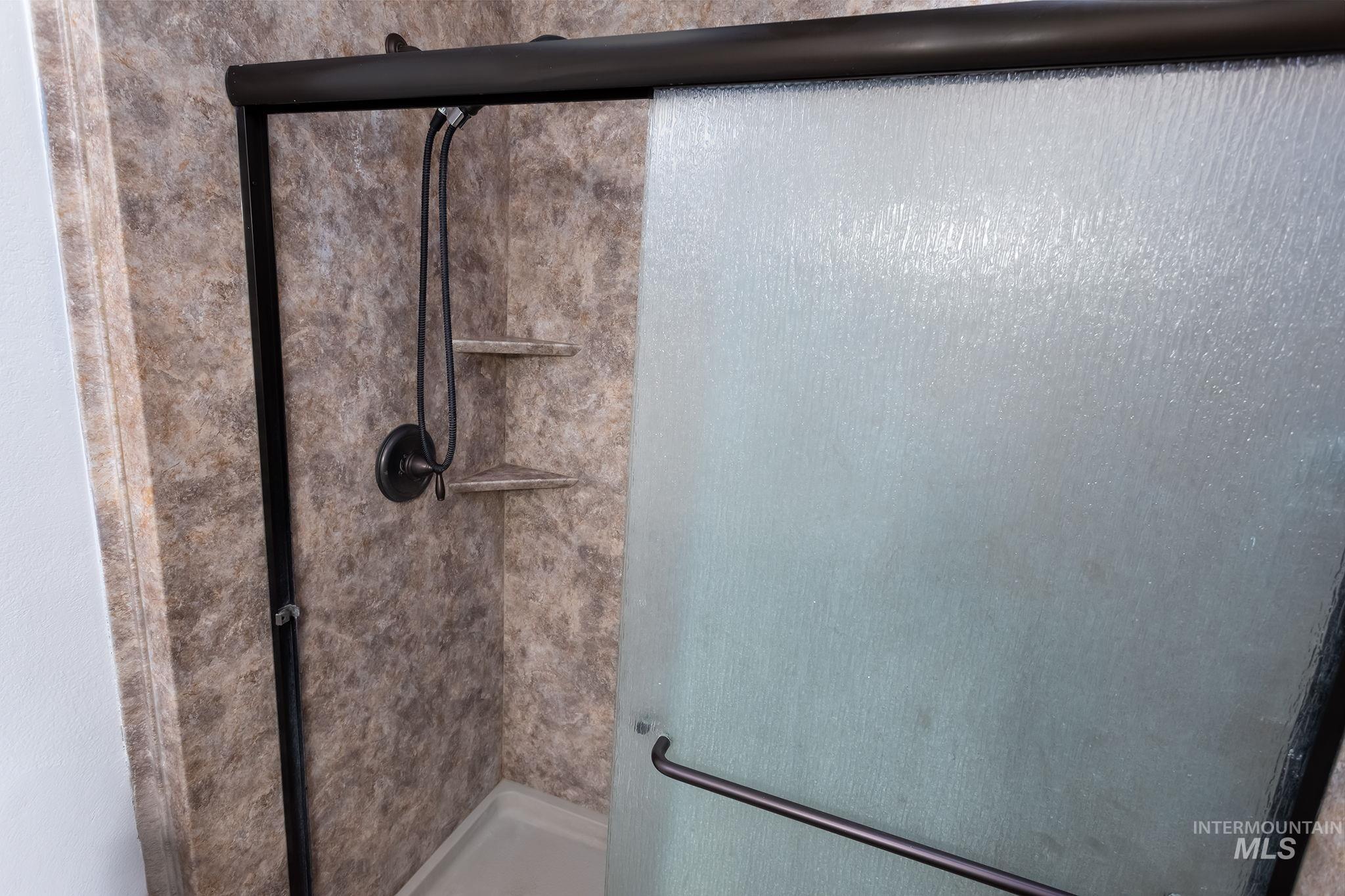 Full bathroom featuring a stall shower