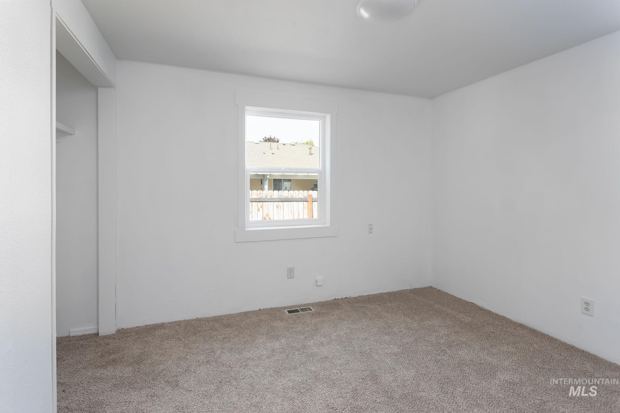 Spare room featuring carpet flooring