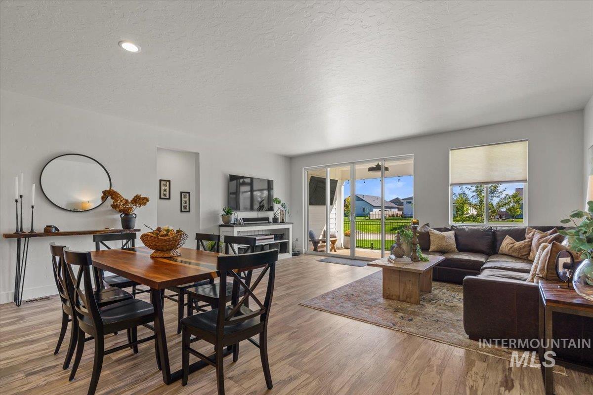 Dining room featuring a textured ceiling, light wood-type flooring, and recessed lighting