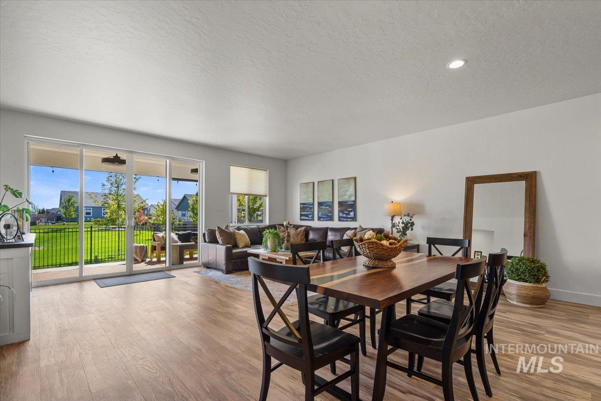 Dining room featuring a textured ceiling, light wood-style floors, and recessed lighting