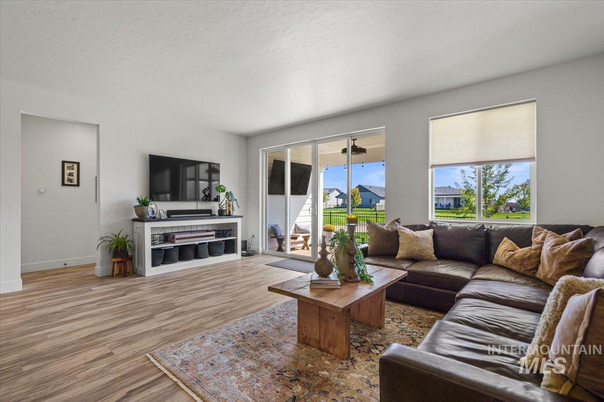 Living area featuring wood finished floors and a textured ceiling