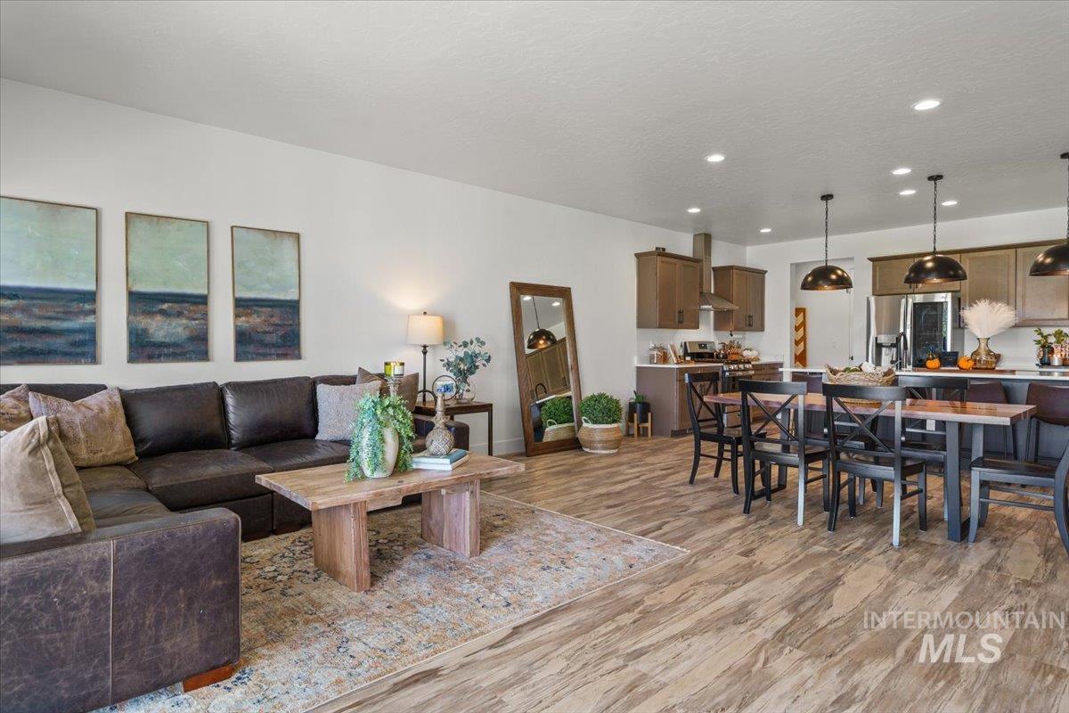 Living area featuring light wood-style floors and recessed lighting