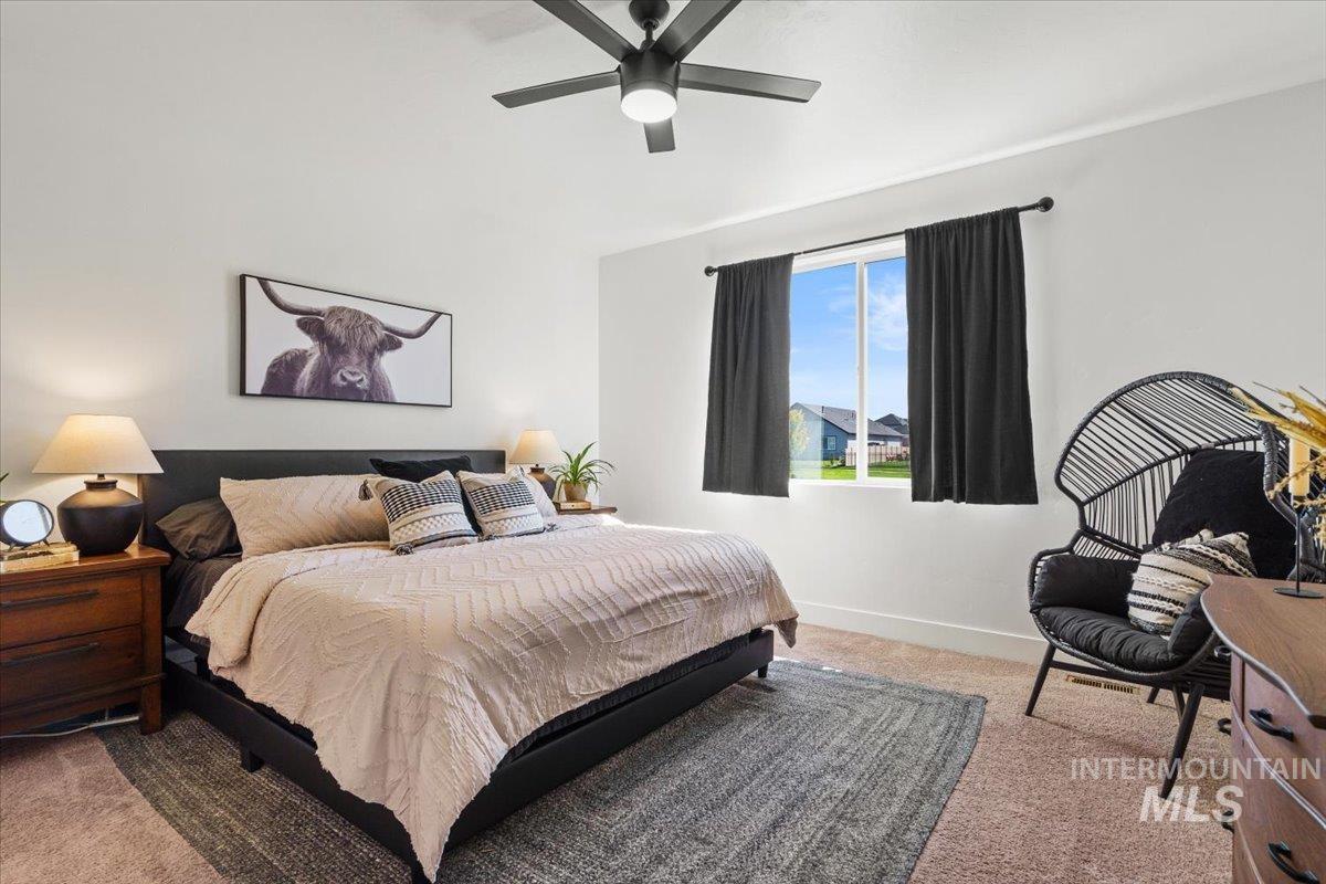 Bedroom featuring carpet flooring and ceiling fan