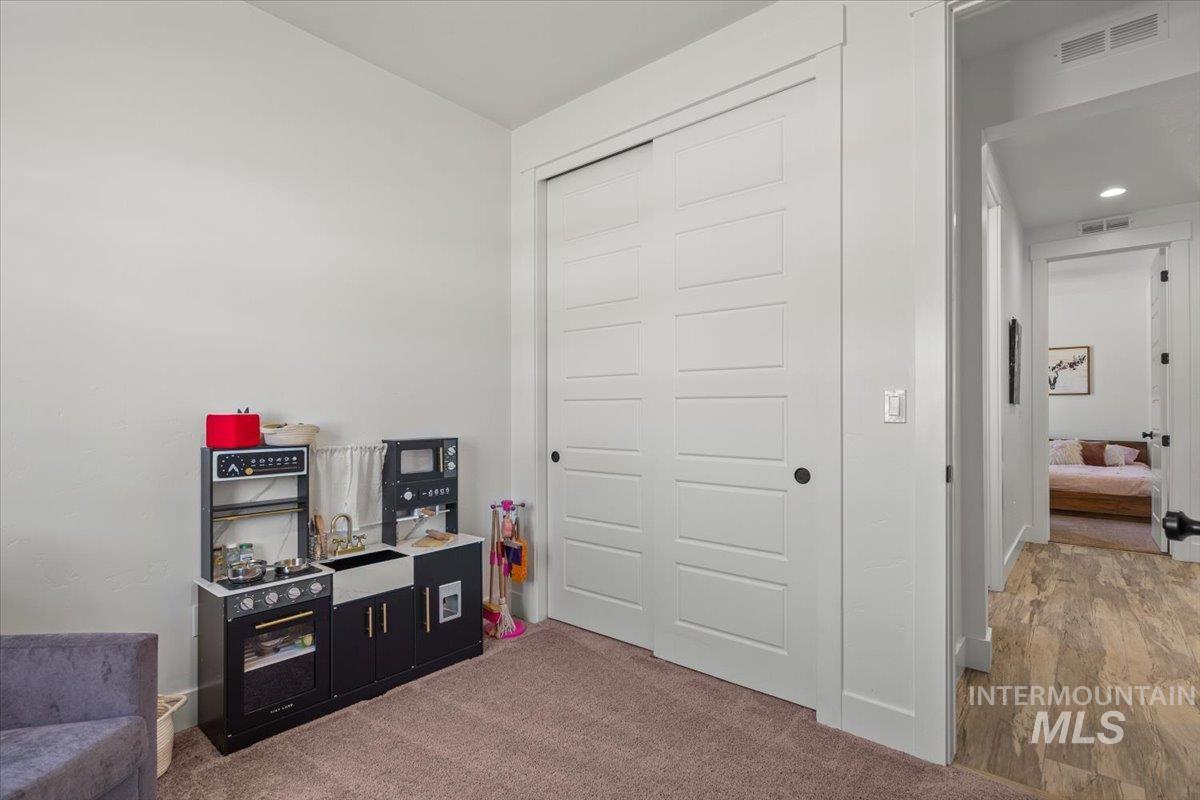 Rec room with carpet flooring
