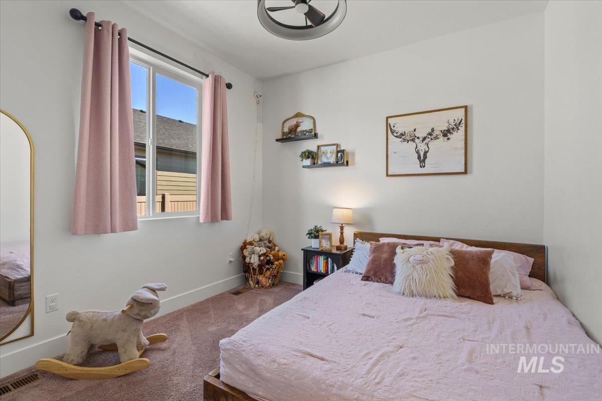 Carpeted bedroom with baseboards