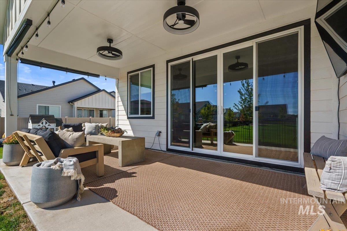 View of patio with an outdoor hangout area and a ceiling fan