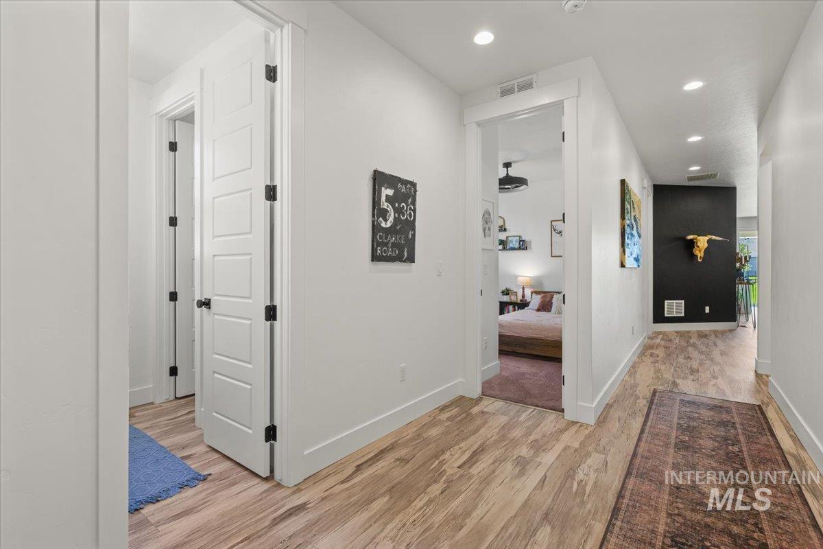 Corridor with recessed lighting and light wood finished floors