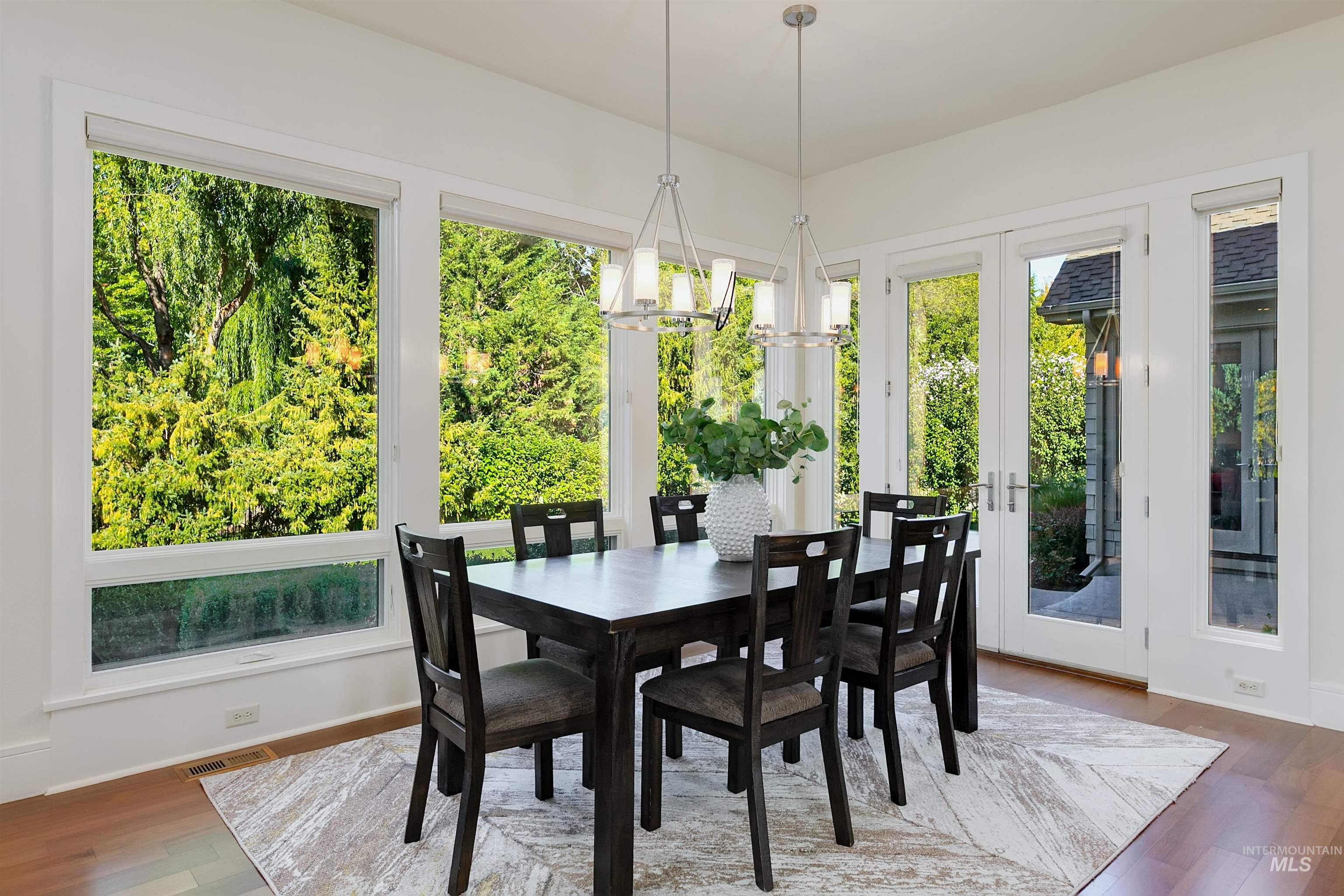 Sunroom with french doors and a chandelier