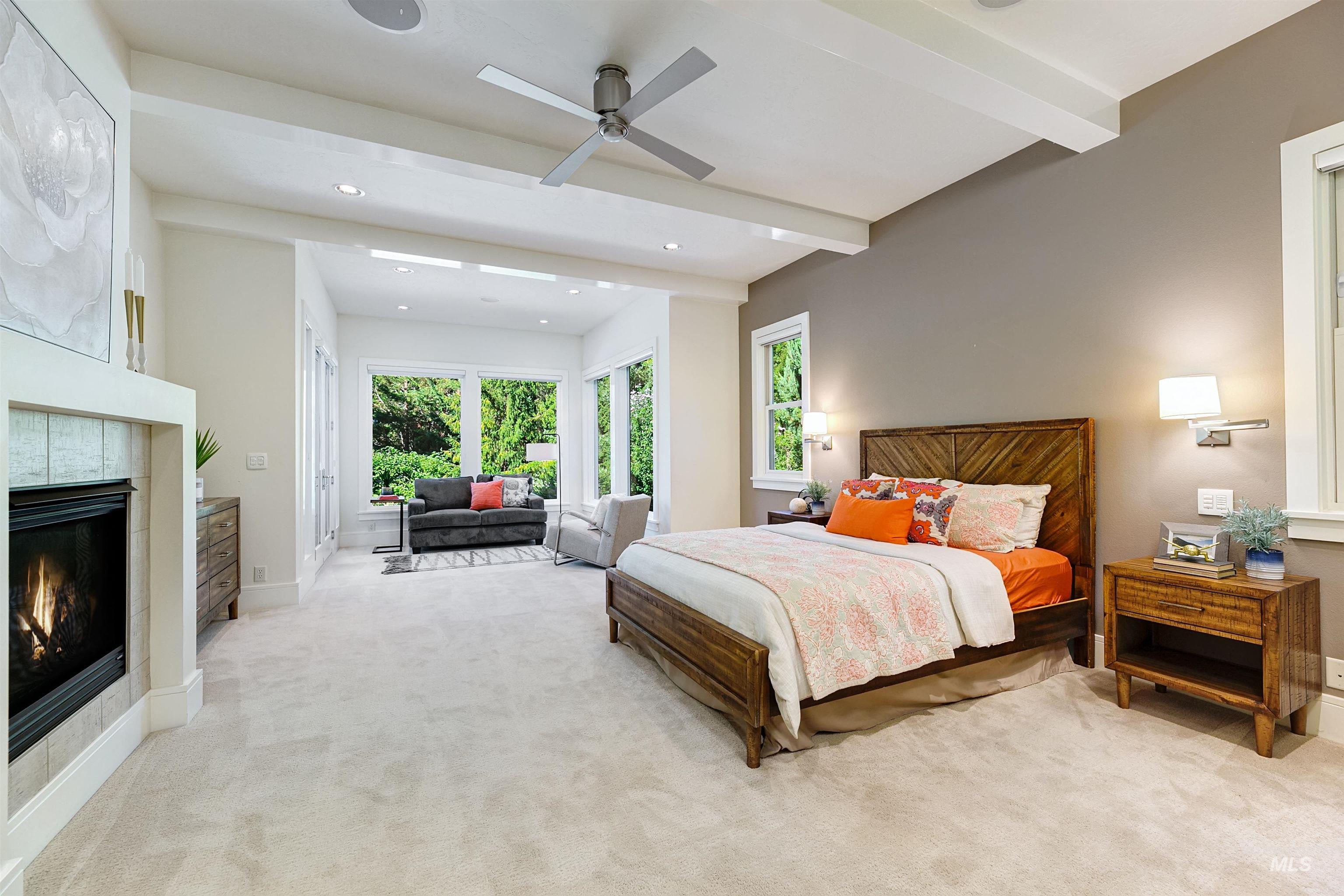 Bedroom with beamed ceiling, light carpet, a tile fireplace, recessed lighting, and ceiling fan