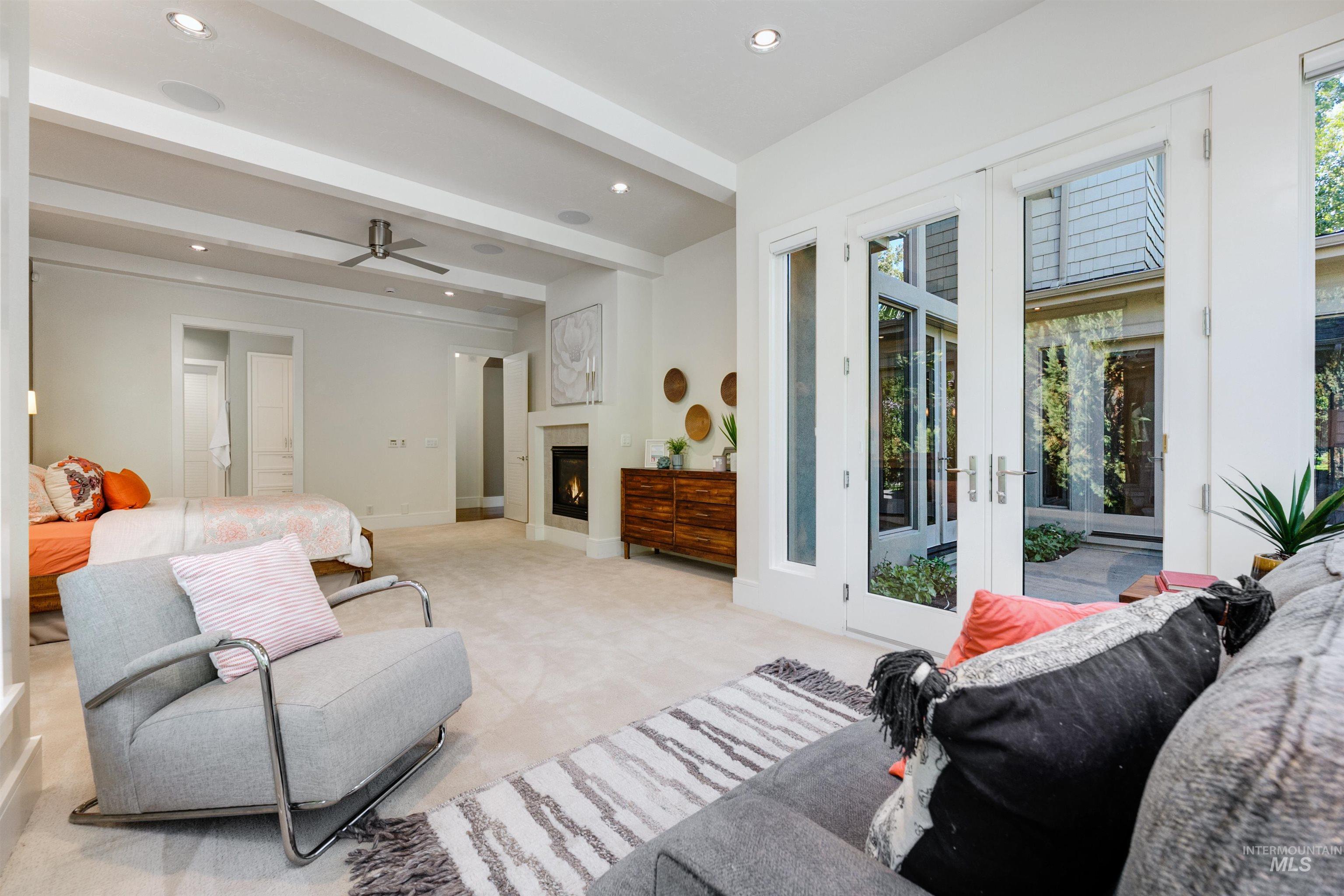 Bedroom featuring beam ceiling, multiple windows, access to exterior, carpet floors, and recessed lighting