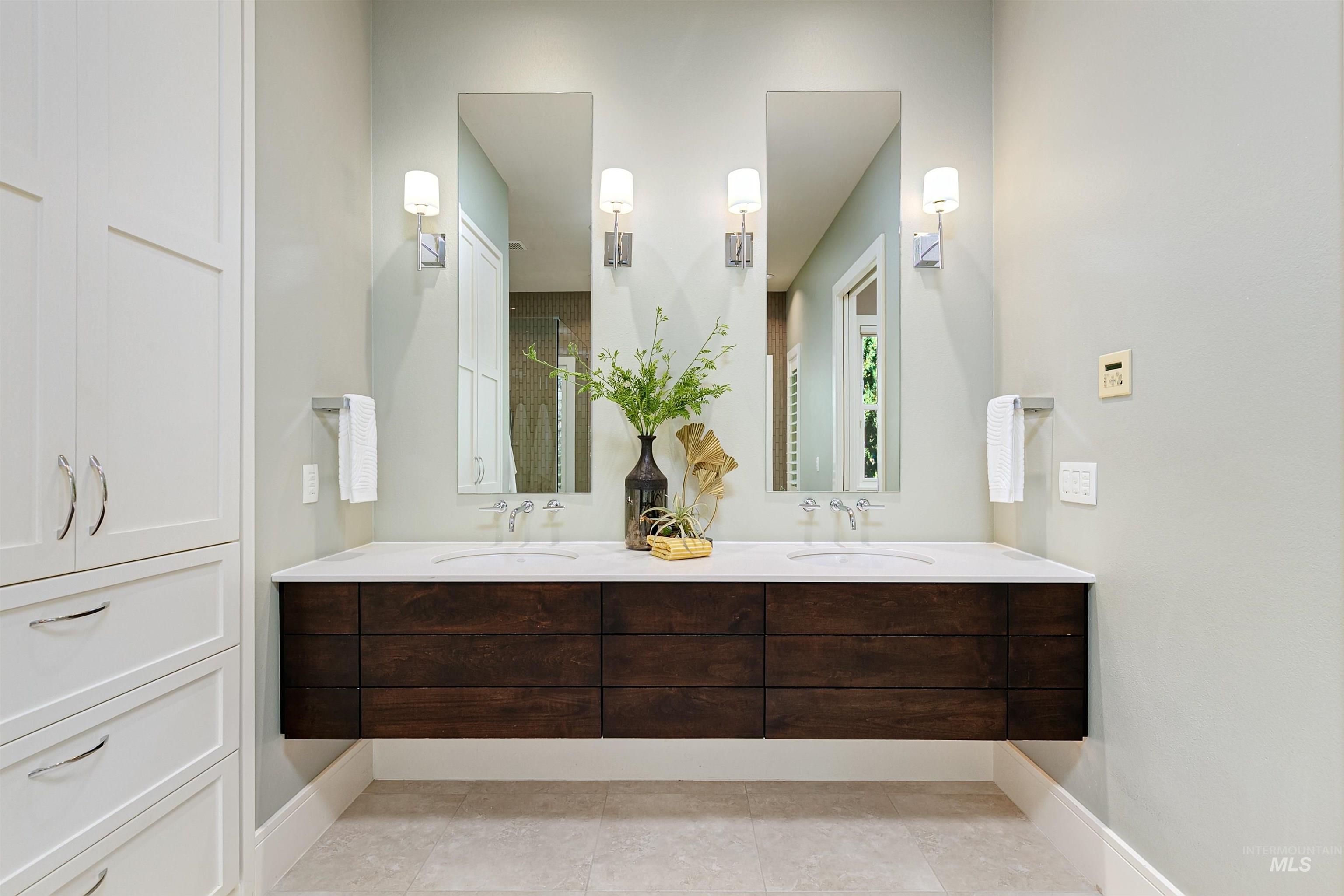 Full bathroom featuring double vanity and light tile patterned floors