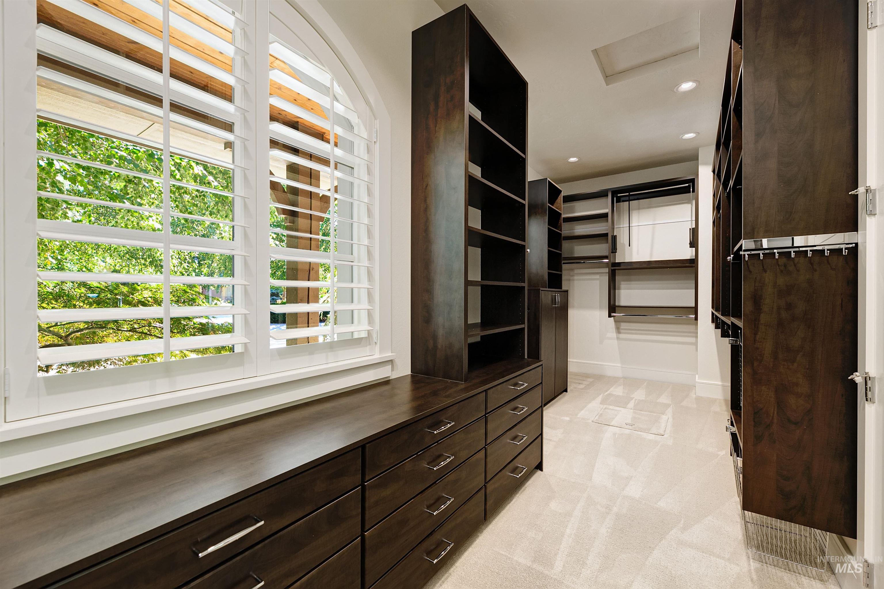 Spacious closet featuring light carpet and attic access