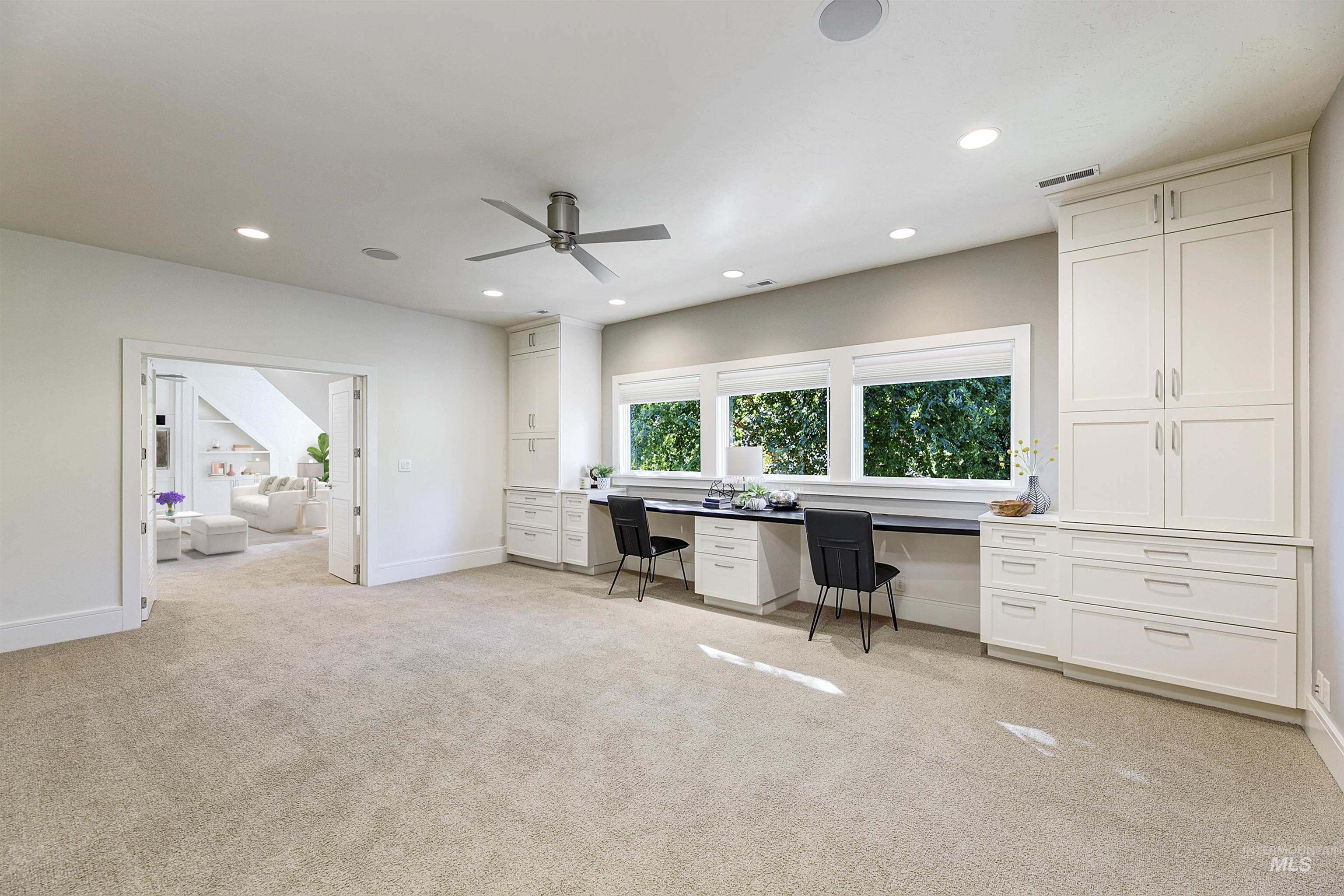 Office featuring built in desk, light colored carpet, recessed lighting, and a ceiling fan