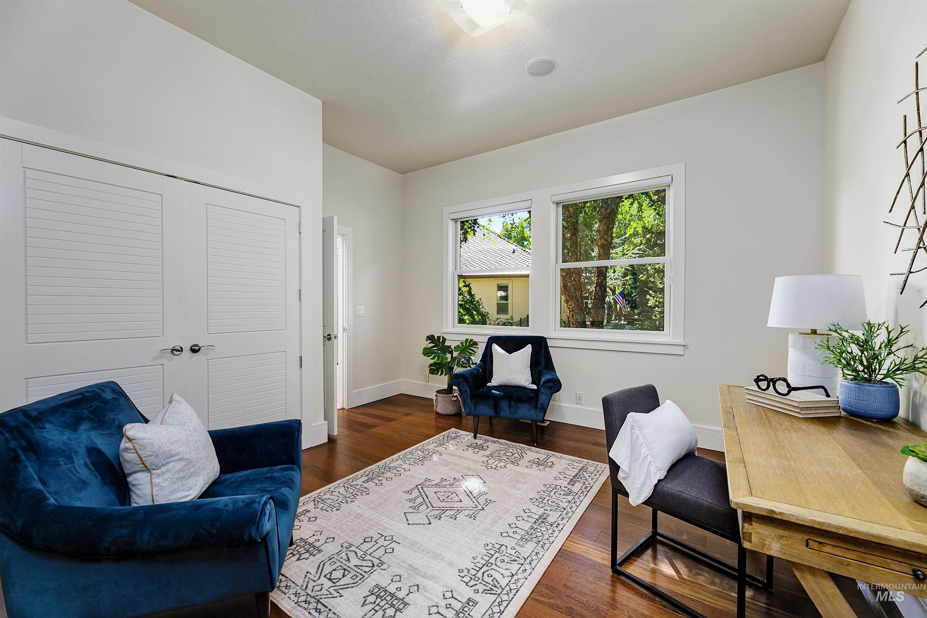 Office area featuring dark wood finished floors and baseboards
