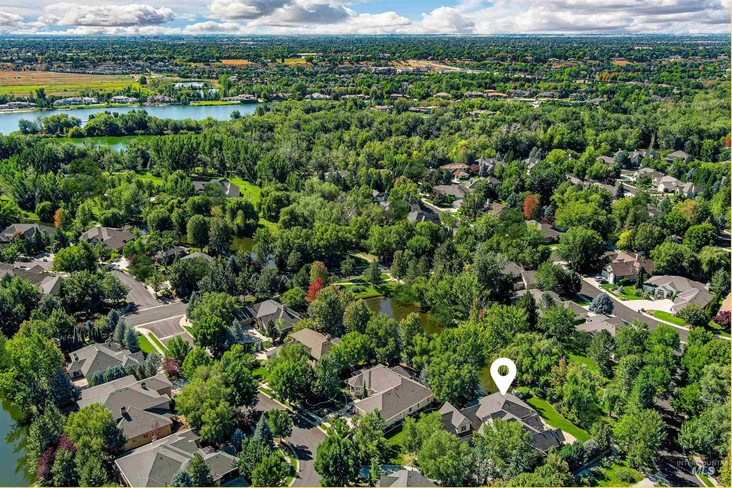 Aerial perspective of suburban area featuring a nearby body of water