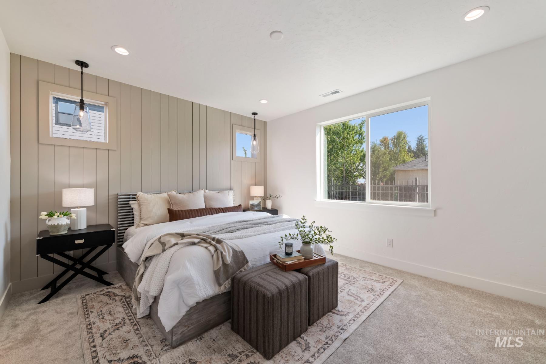 Bedroom featuring multiple windows, light carpet, and recessed lighting