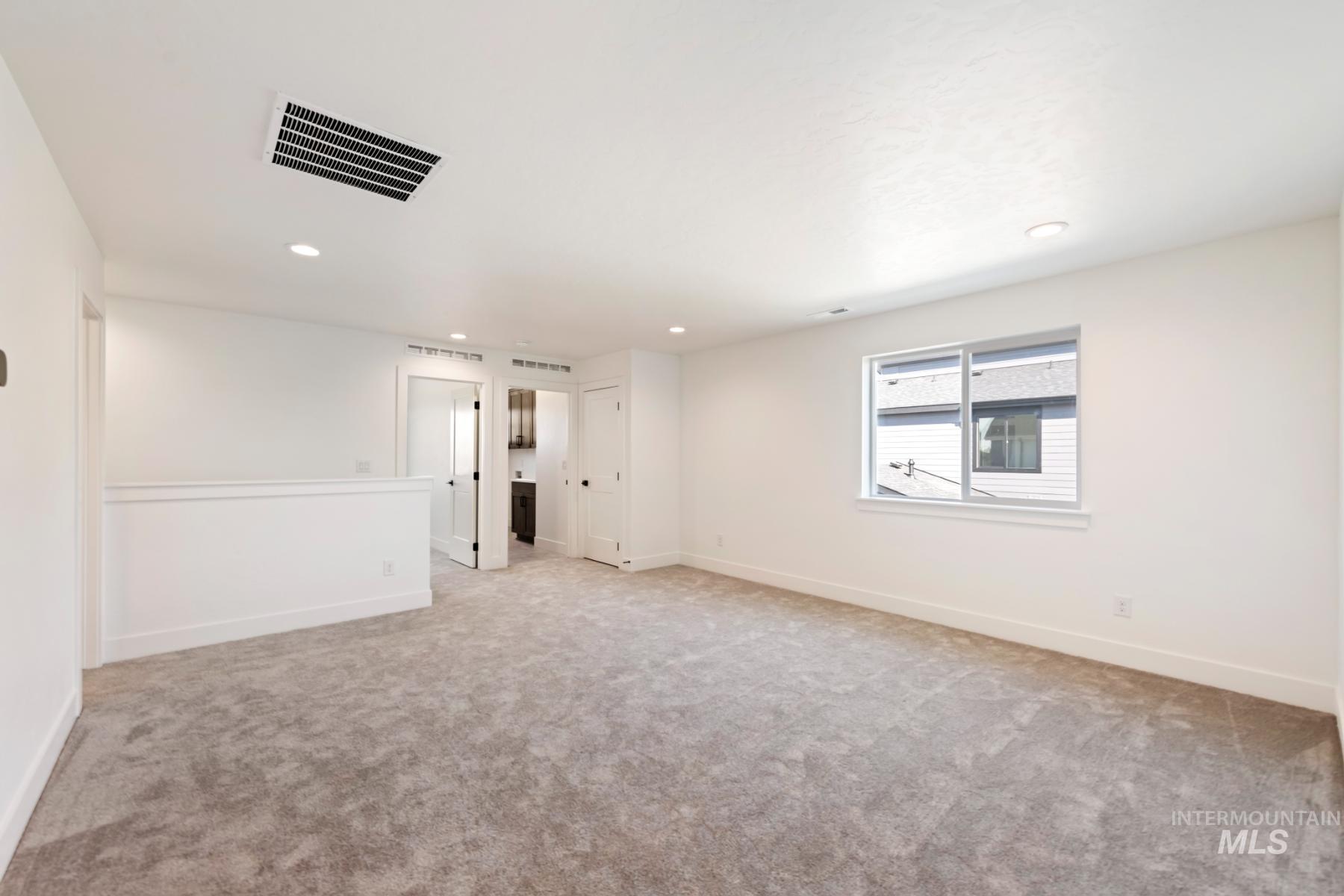 Unfurnished room featuring light colored carpet and recessed lighting