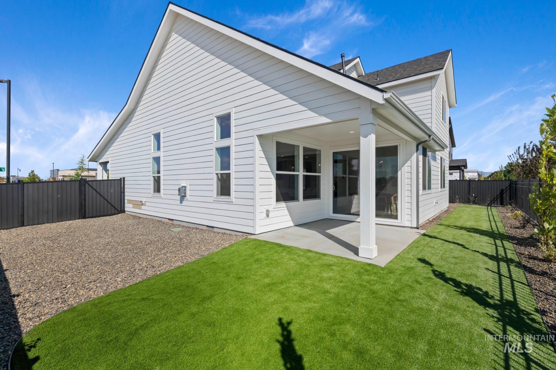 Back of house featuring a fenced backyard and a patio