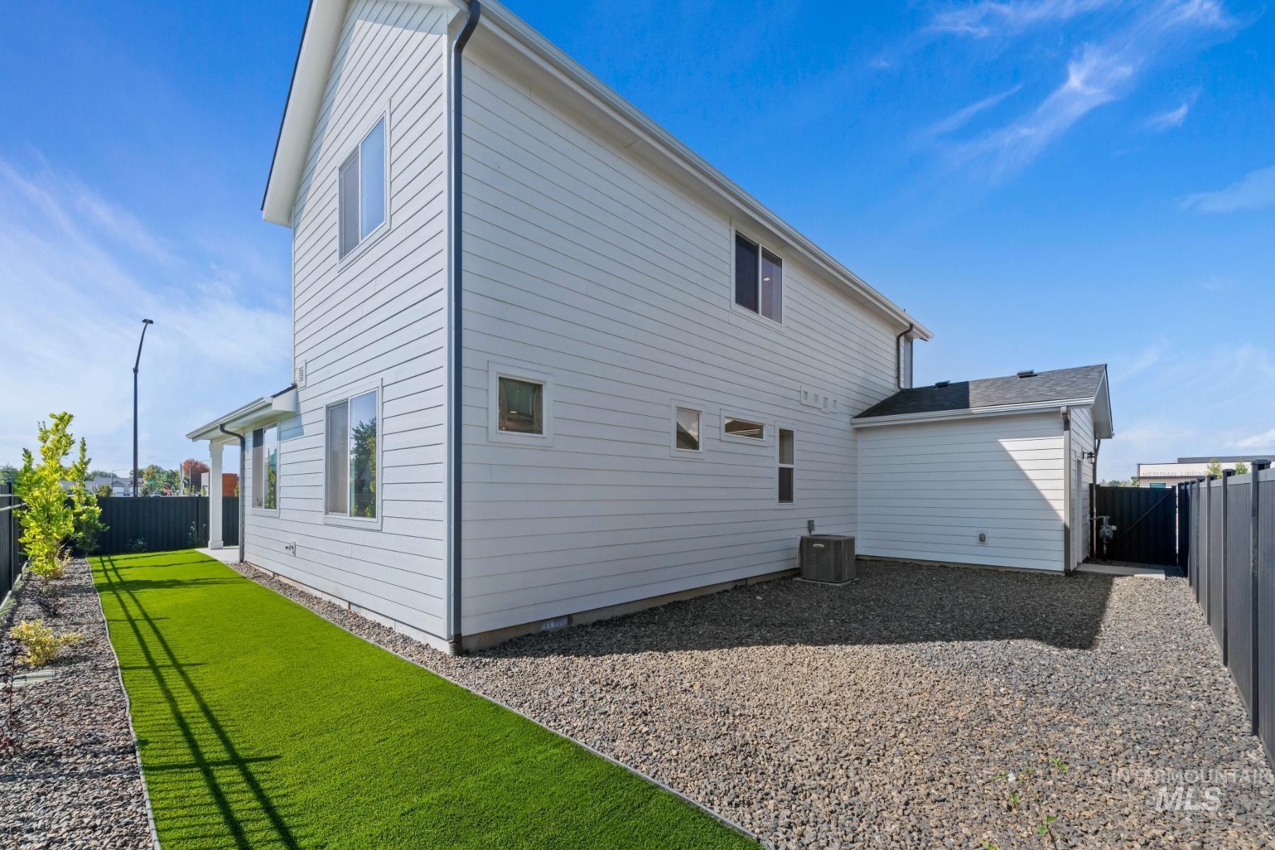 Rear view of property with a fenced backyard