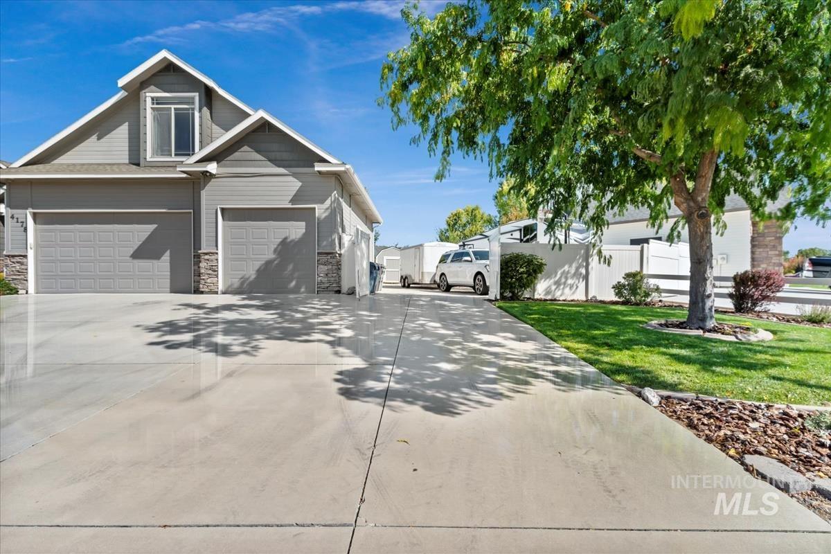 View of home's exterior with concrete driveway, a garage, and stone siding