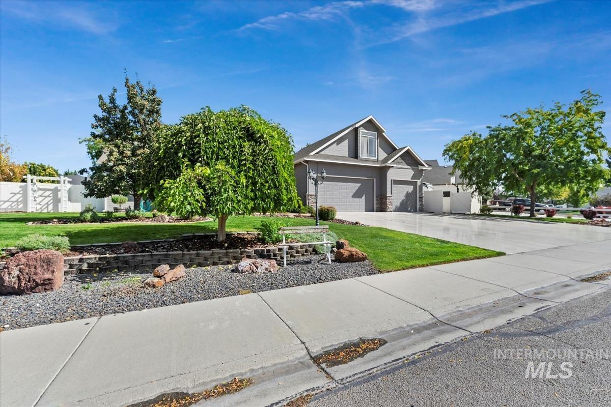 View of front facade featuring driveway and an attached garage