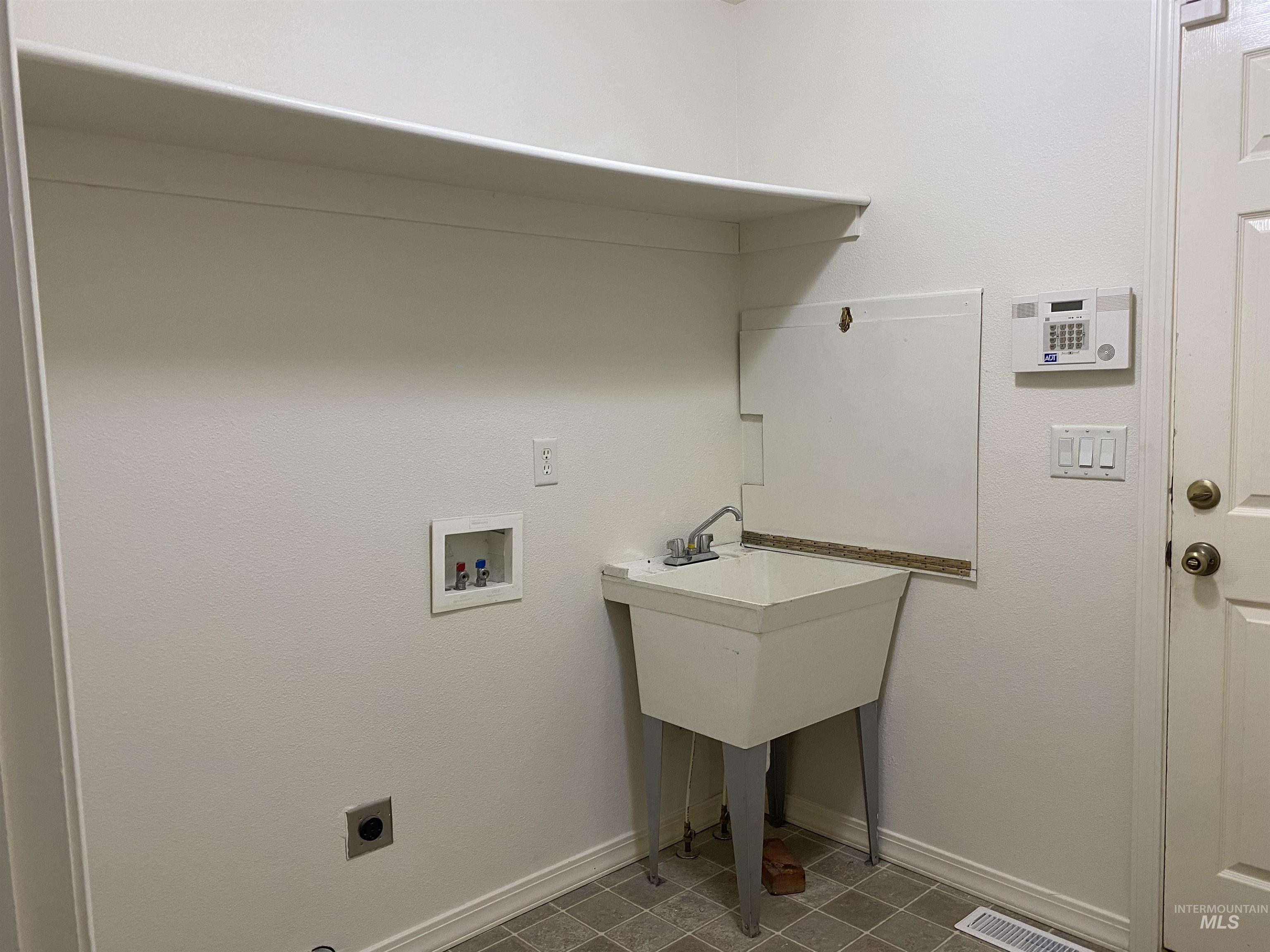 Washroom featuring washer hookup, tile patterned flooring, and hookup for an electric dryer