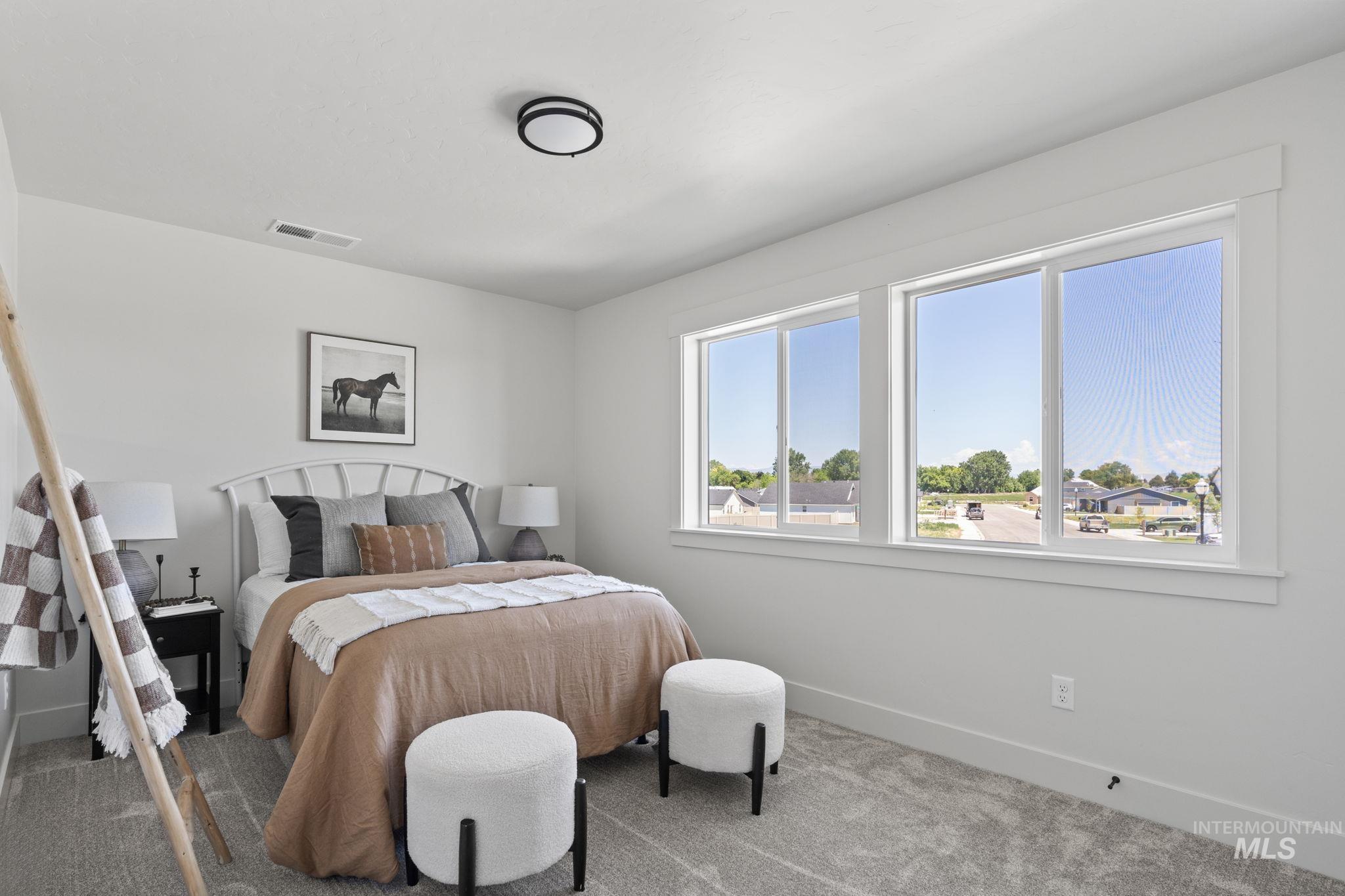 Bedroom featuring baseboards and carpet floors