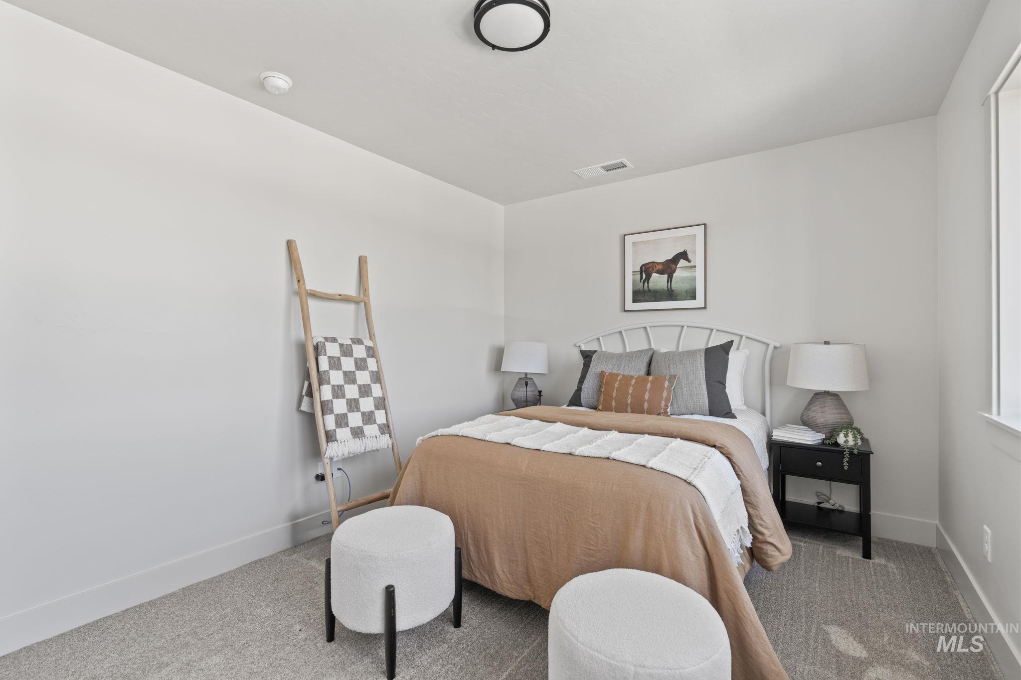 Bedroom with carpet floors and baseboards
