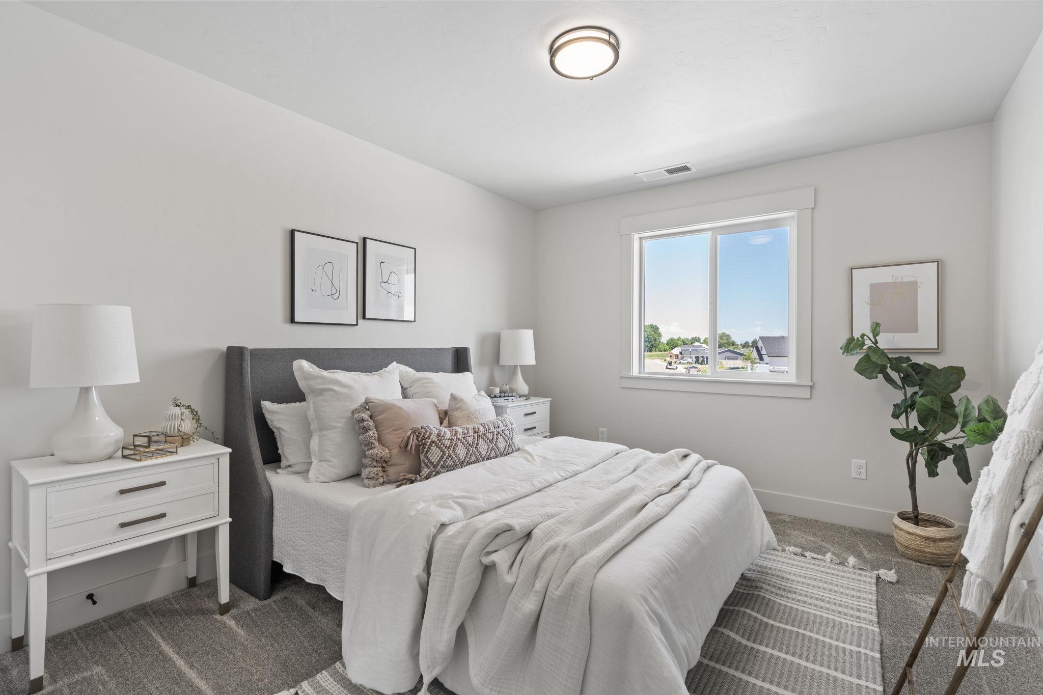 Carpeted bedroom featuring baseboards