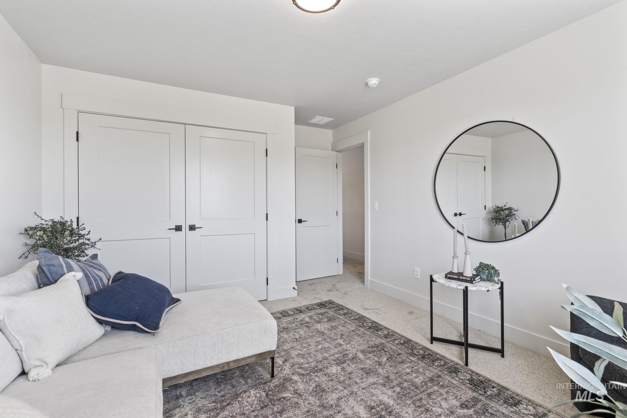 Living area featuring carpet floors and baseboards