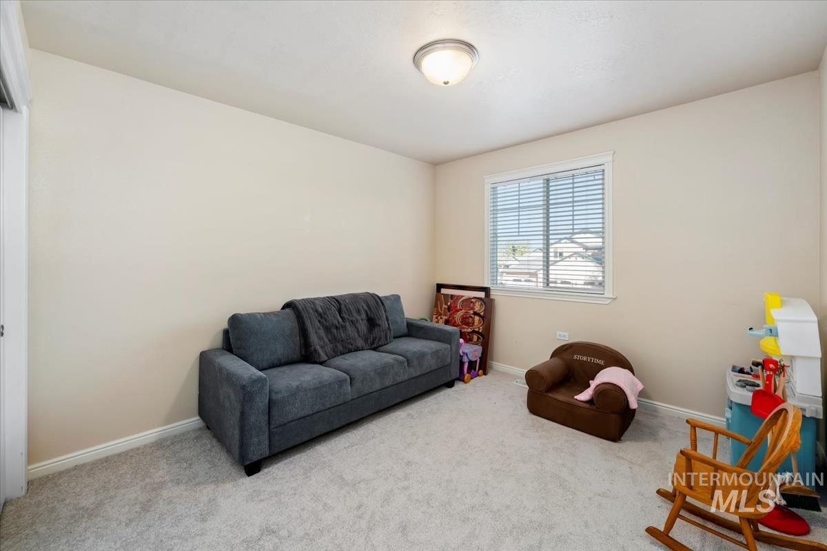 Living area with carpet flooring and baseboards