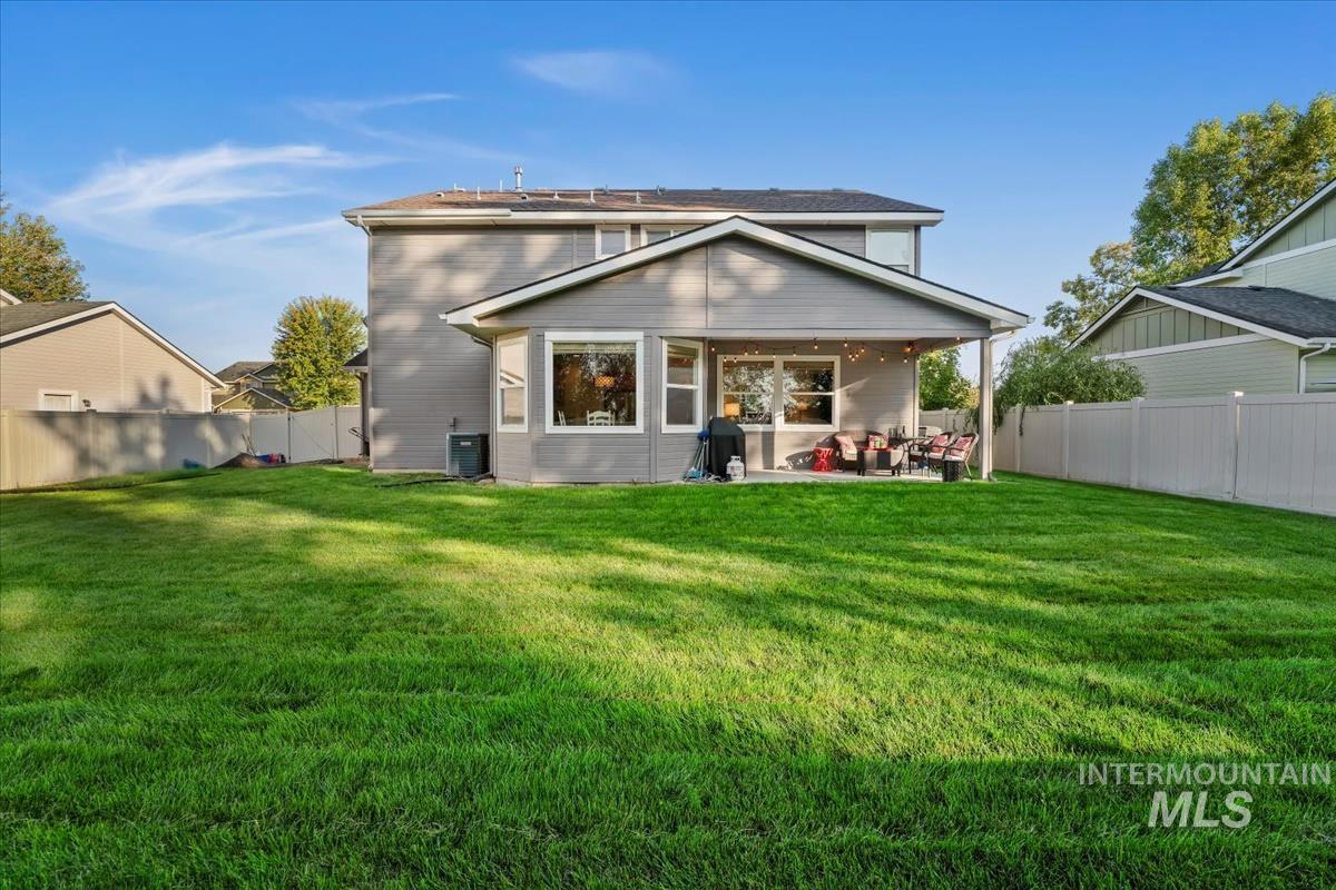 Rear view of house with a patio area and a fenced backyard