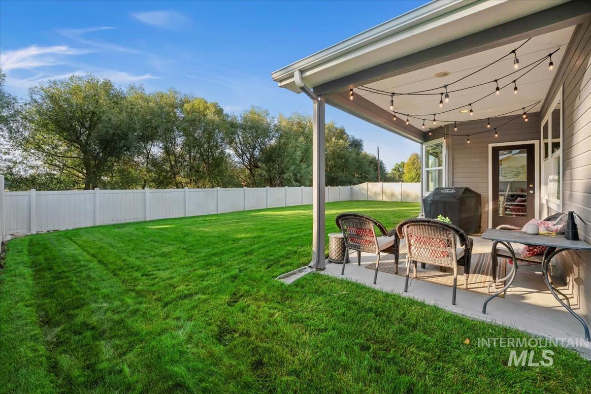 Fenced backyard with a patio area