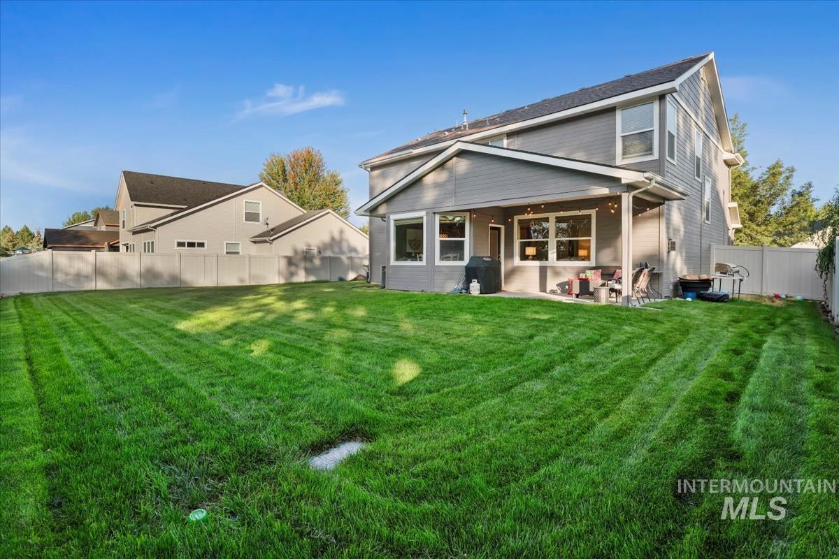 Back of property with a fenced backyard and a patio area