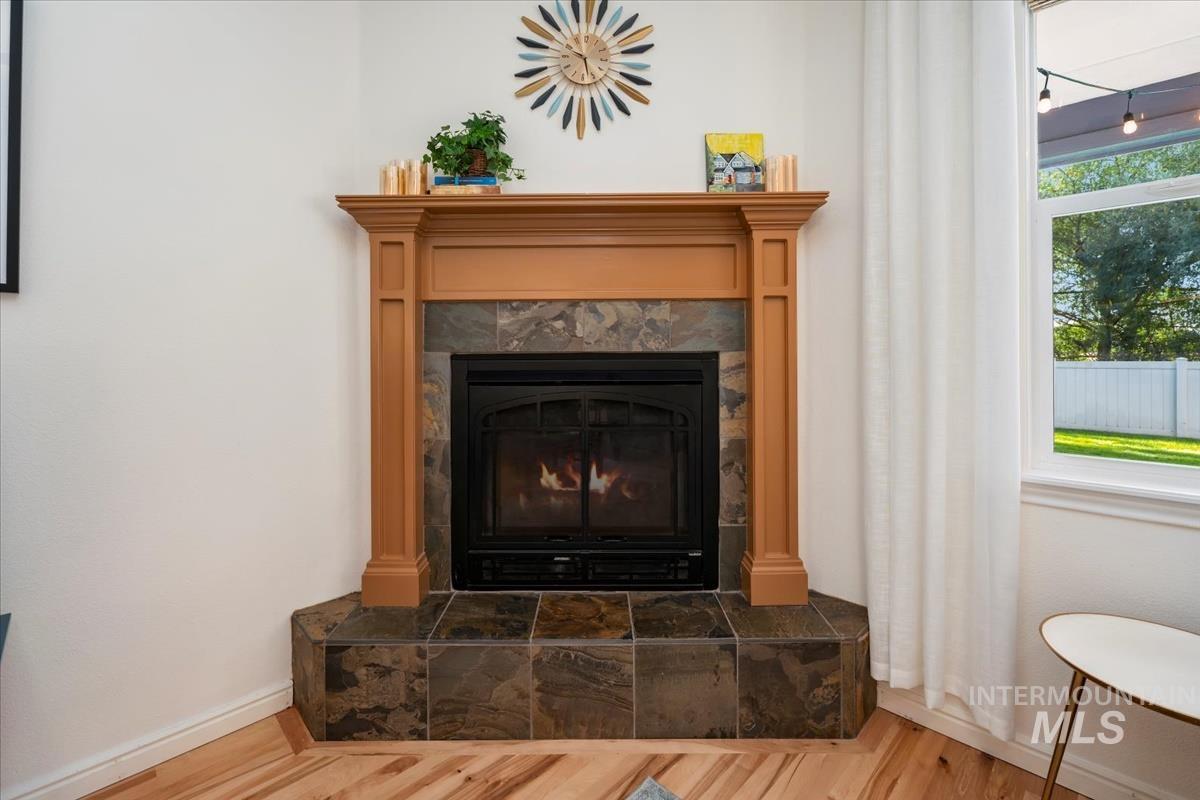 Detailed view of a tile fireplace and wood finished floors