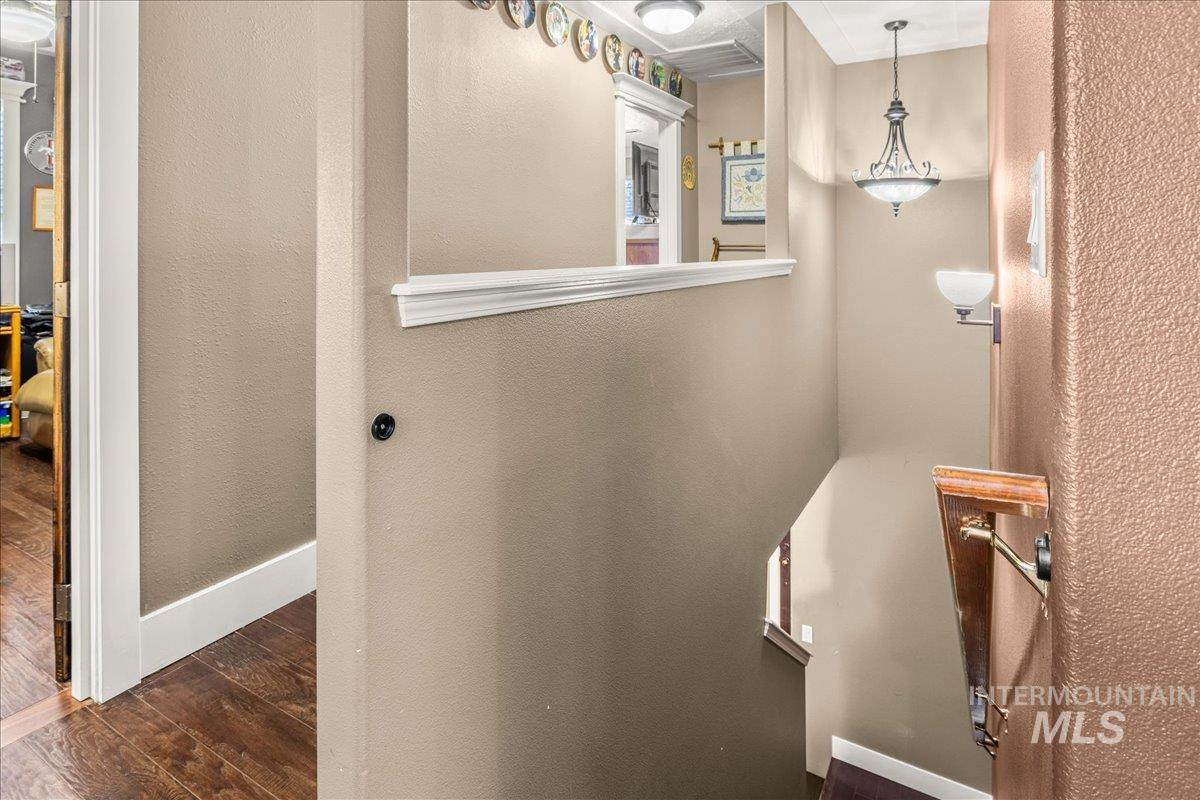 Bathroom with dark wood-type flooring and a textured wall