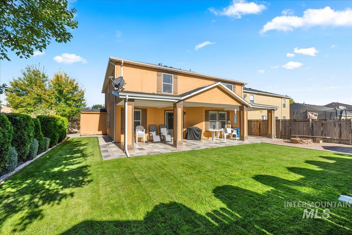 Back of property with a patio area, stucco siding, and a fenced backyard