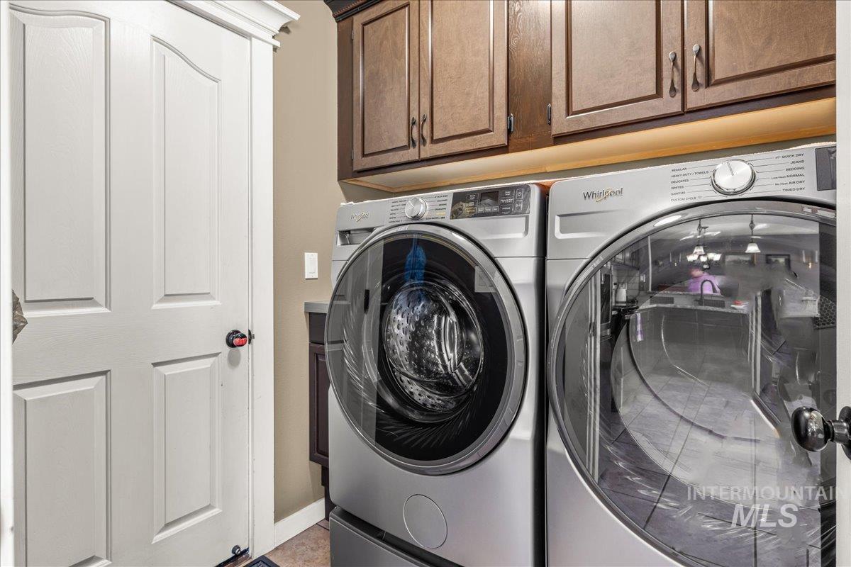 Laundry room with cabinet space and independent washer and dryer