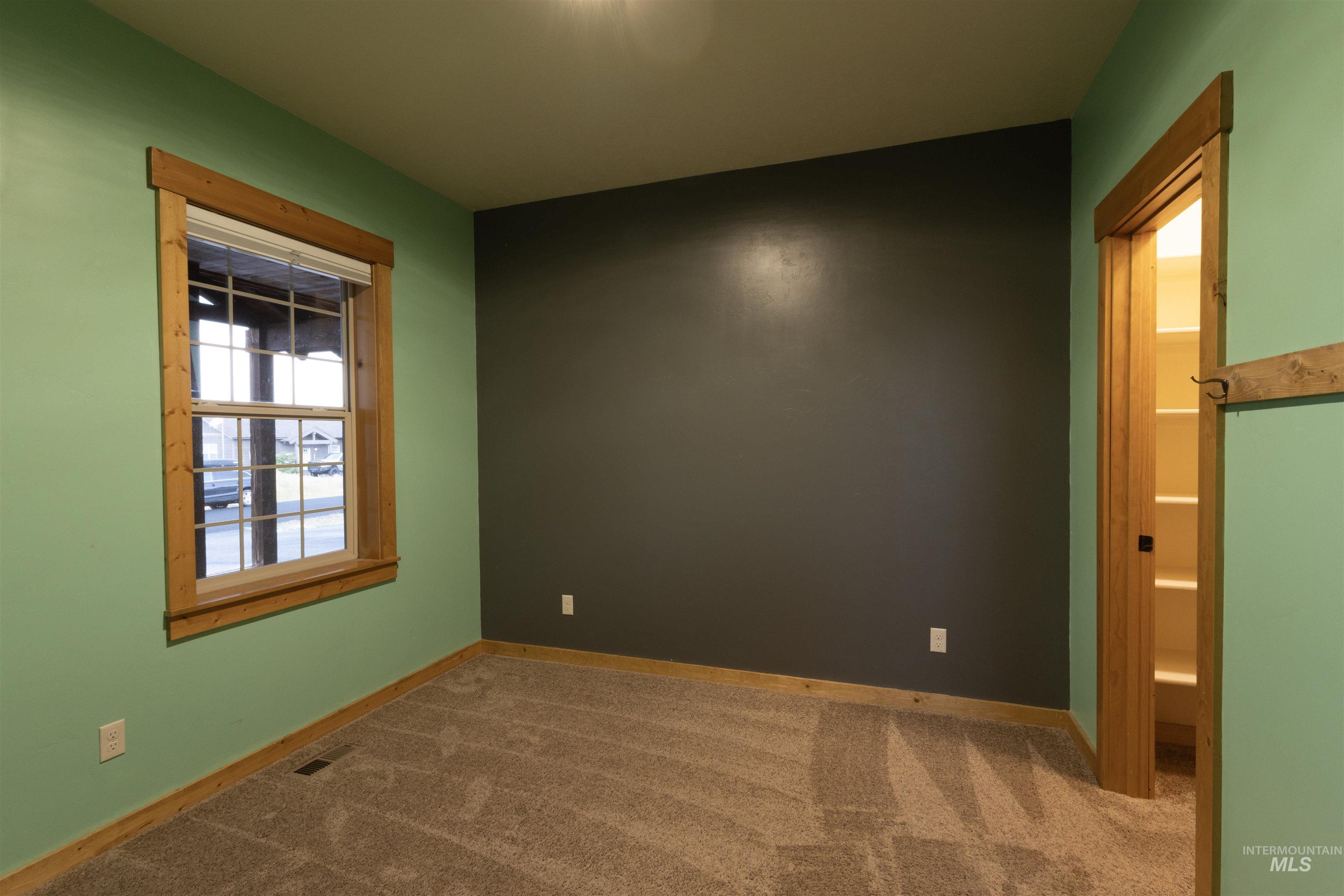 Empty room with carpet and baseboards