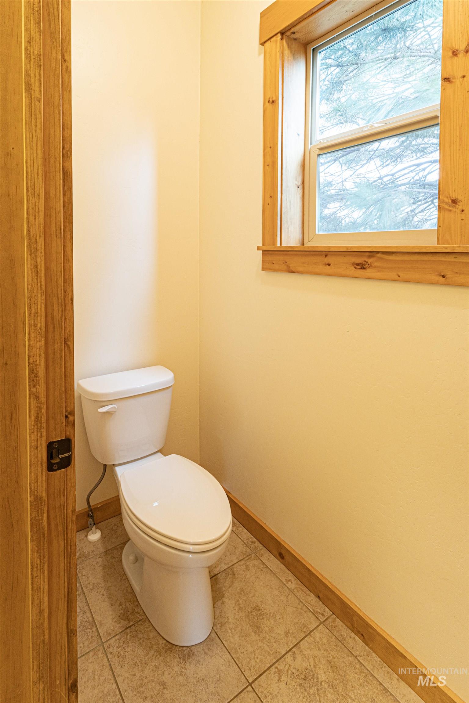Half bath with light tile patterned floors