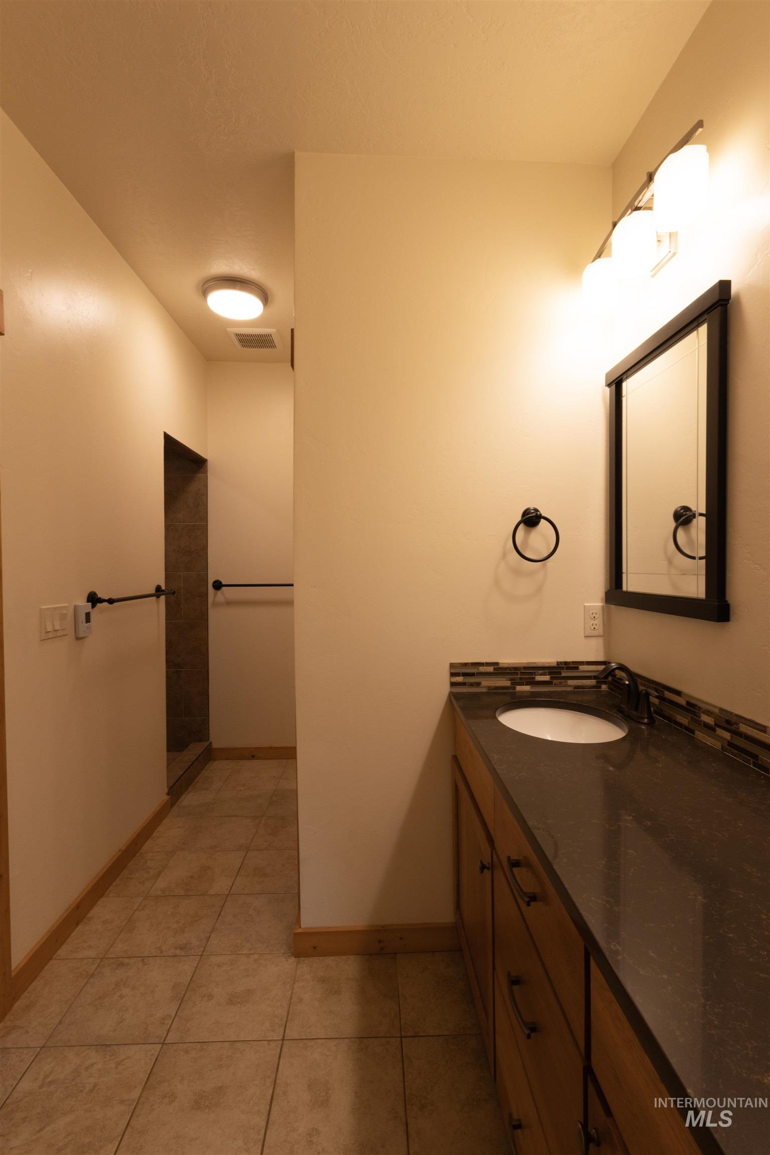 Bathroom featuring vanity and light tile patterned floors