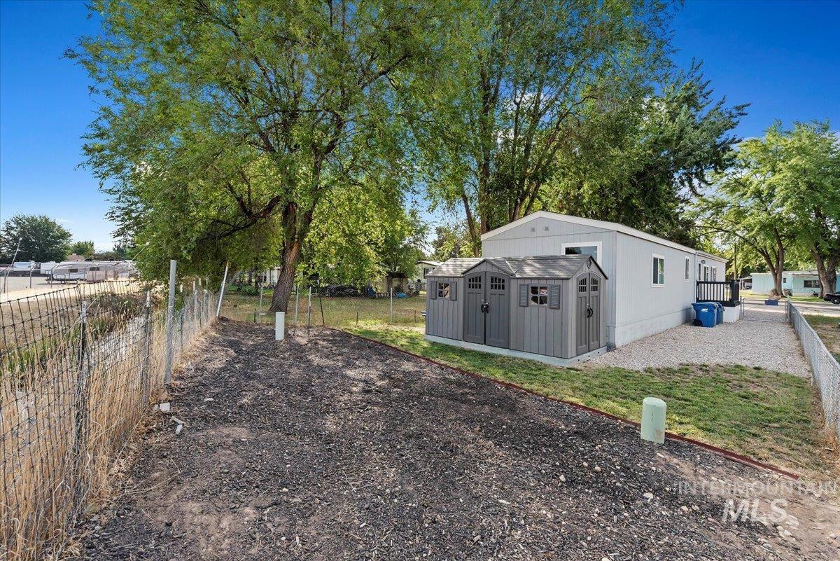 View of yard with a storage unit