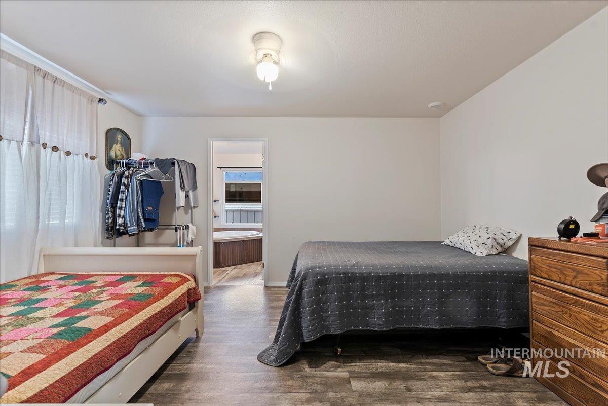 Bedroom with wood finished floors and baseboards