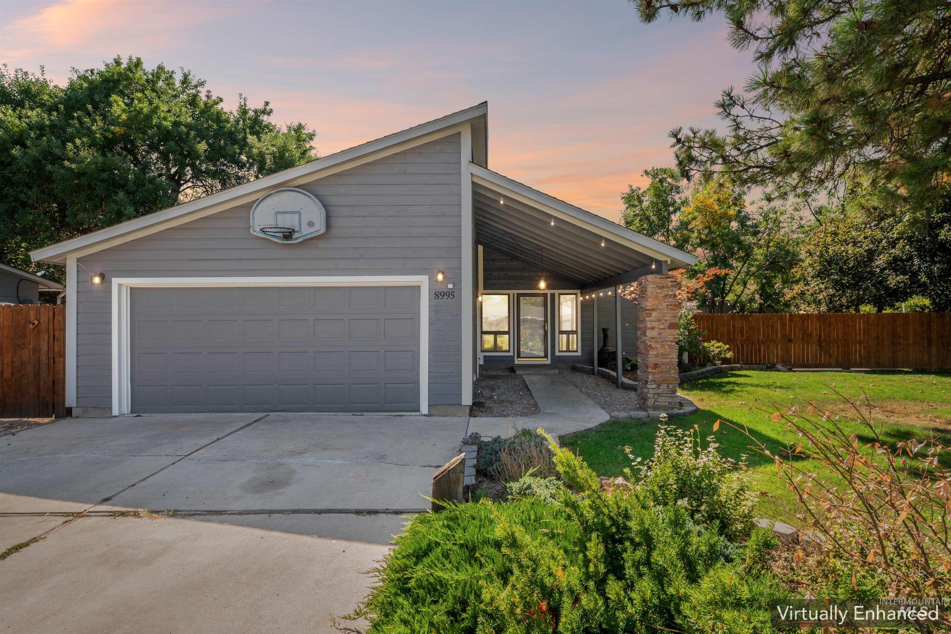 Mid-century inspired home featuring a large covered patio, driveway, and a garage