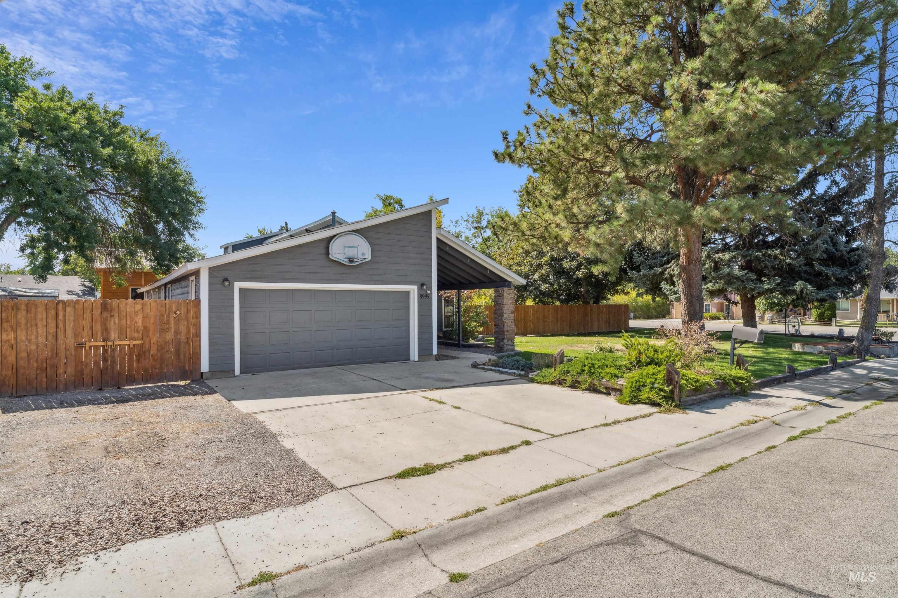View of front of home with a garage and concrete driveway