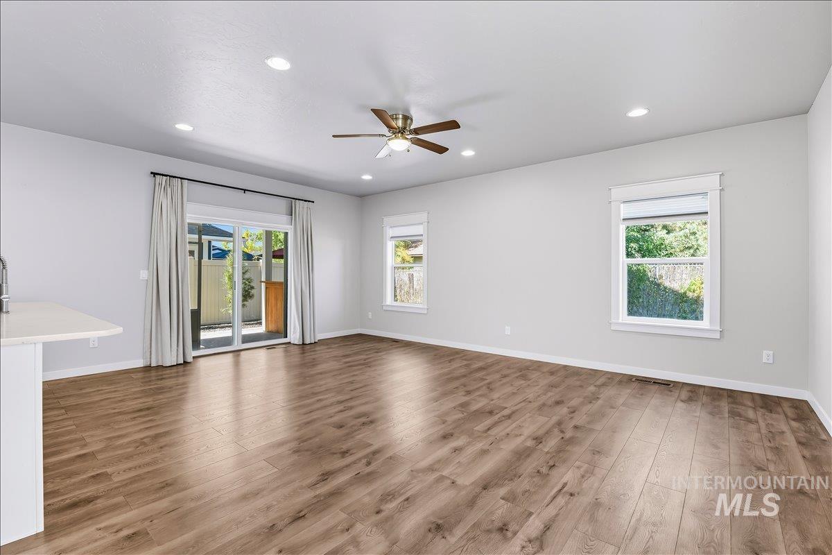 Spare room featuring light wood-style flooring, healthy amount of natural light, recessed lighting, and a ceiling fan