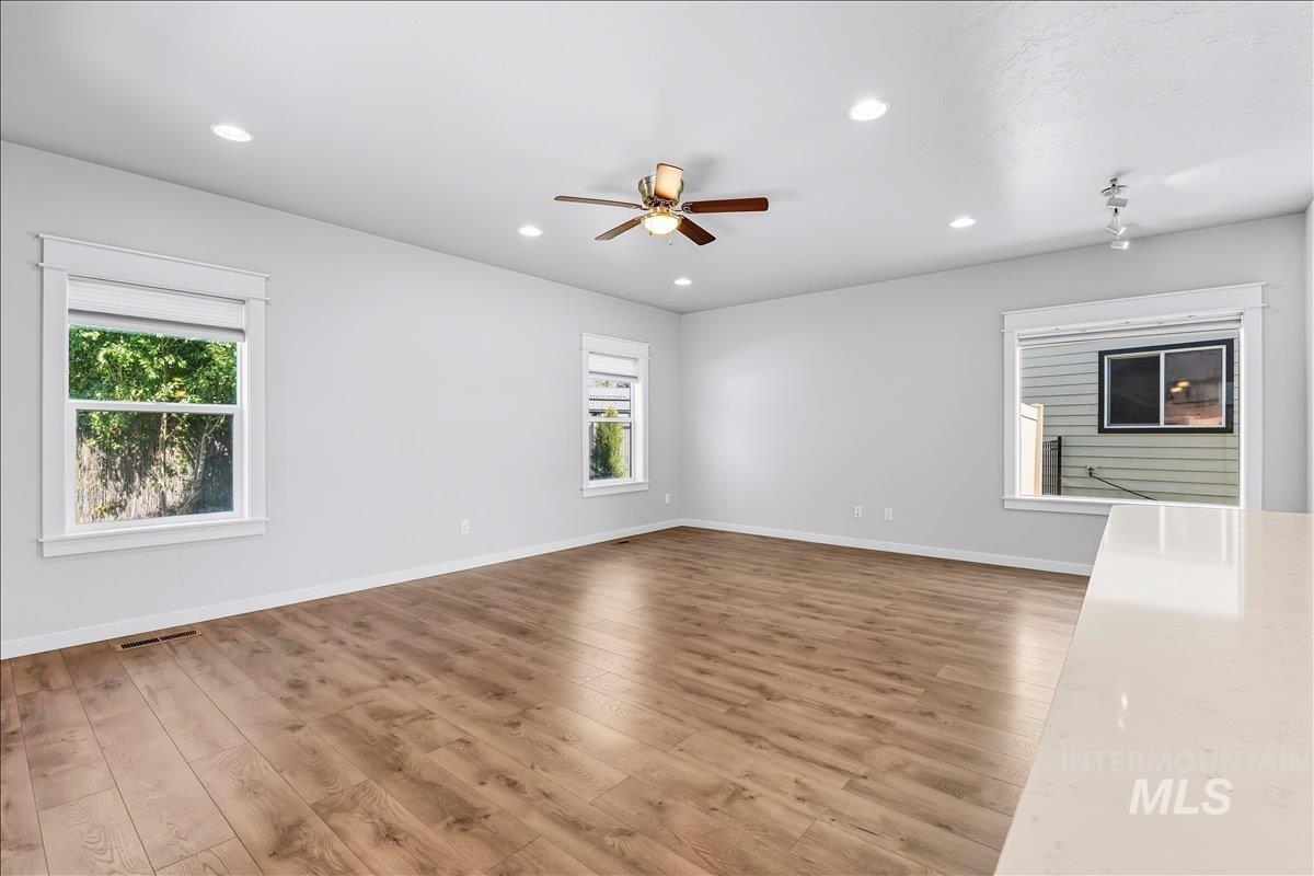 Unfurnished living room with recessed lighting, light wood-style floors, and a ceiling fan